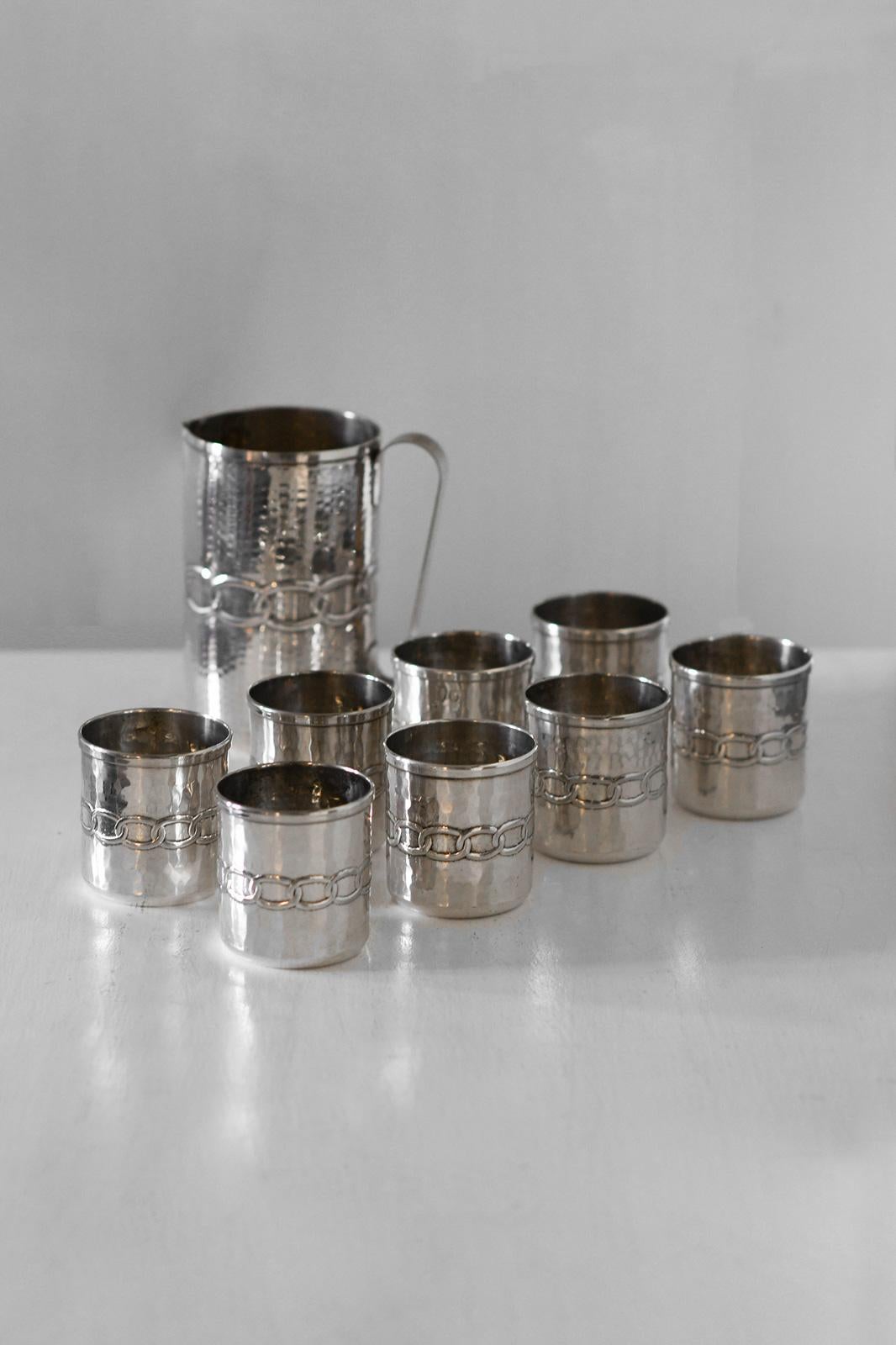Set of 8 Glasses + 1 Pitcher by Argentieri Fratelli Calegaro, 1968
Product Details
Made of silver with a hammered body and embossed decoration, gold-plated interiors.
Glass dimensions: 8 D x 9 H cm
Pitcher dimensions: 12 D x 18 H cm