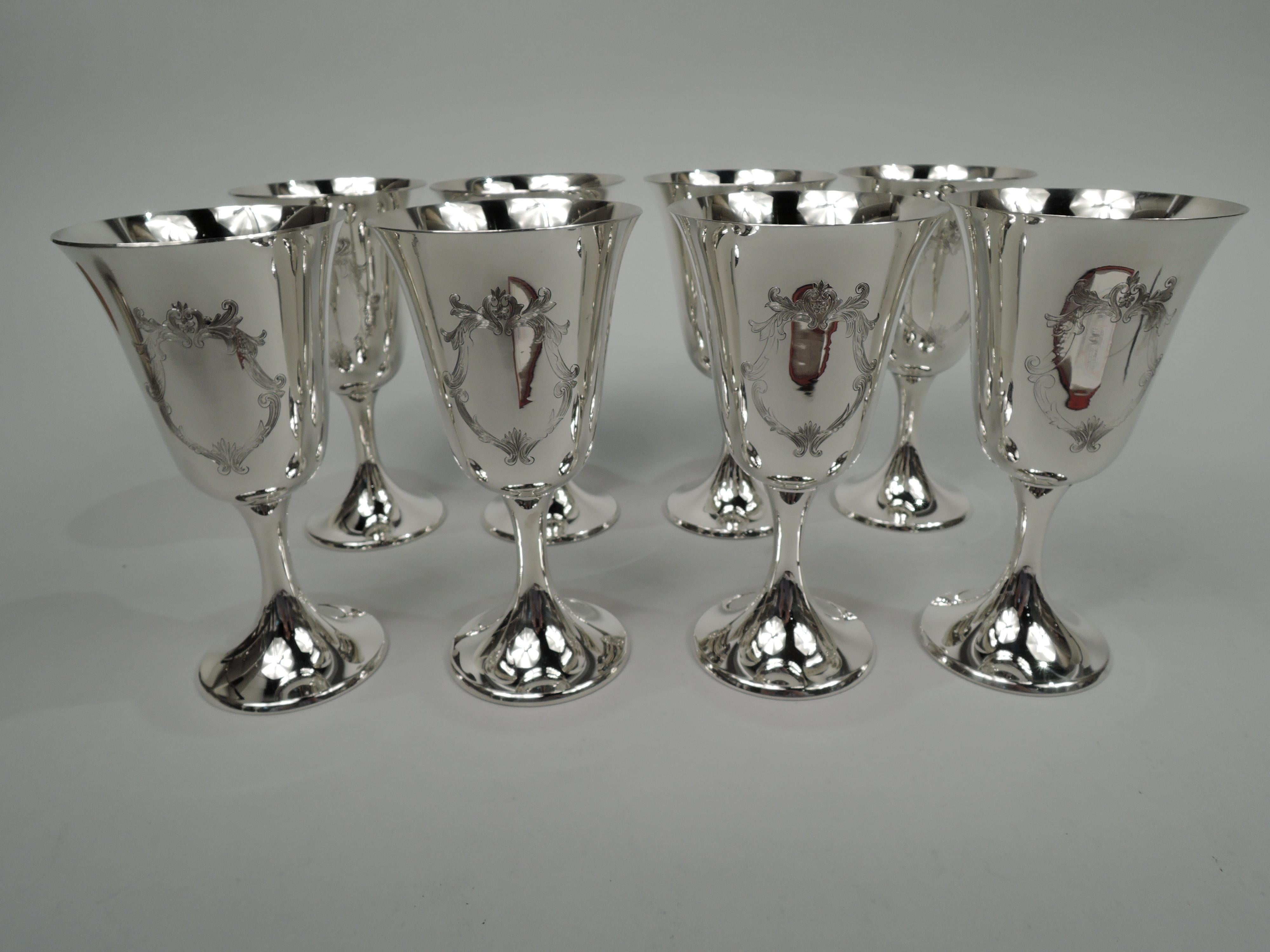 Set of 8 Engraved Puritan sterling silver goblets. Made by Gorham in Providence. Each: Spare and elegant form with subtle bell-form bowl on cylindrical stem flowing into raised foot. Engraved leafing scroll frame (vacant). Works best when filled and