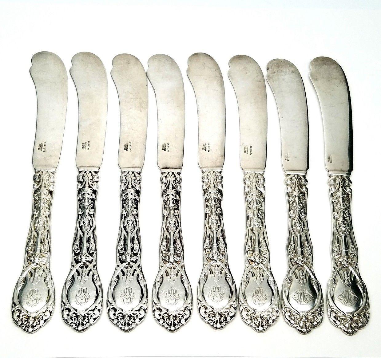 Set of 8 Gorham sterling silver butter knives in the Mythologique pattern. Of the 8 knives, there are 2 different monograms. See below for monogram details. Marked: lion anchor G STERLING PAT 1895. Monogram: W on 6 knives, appears to be JD on 2
