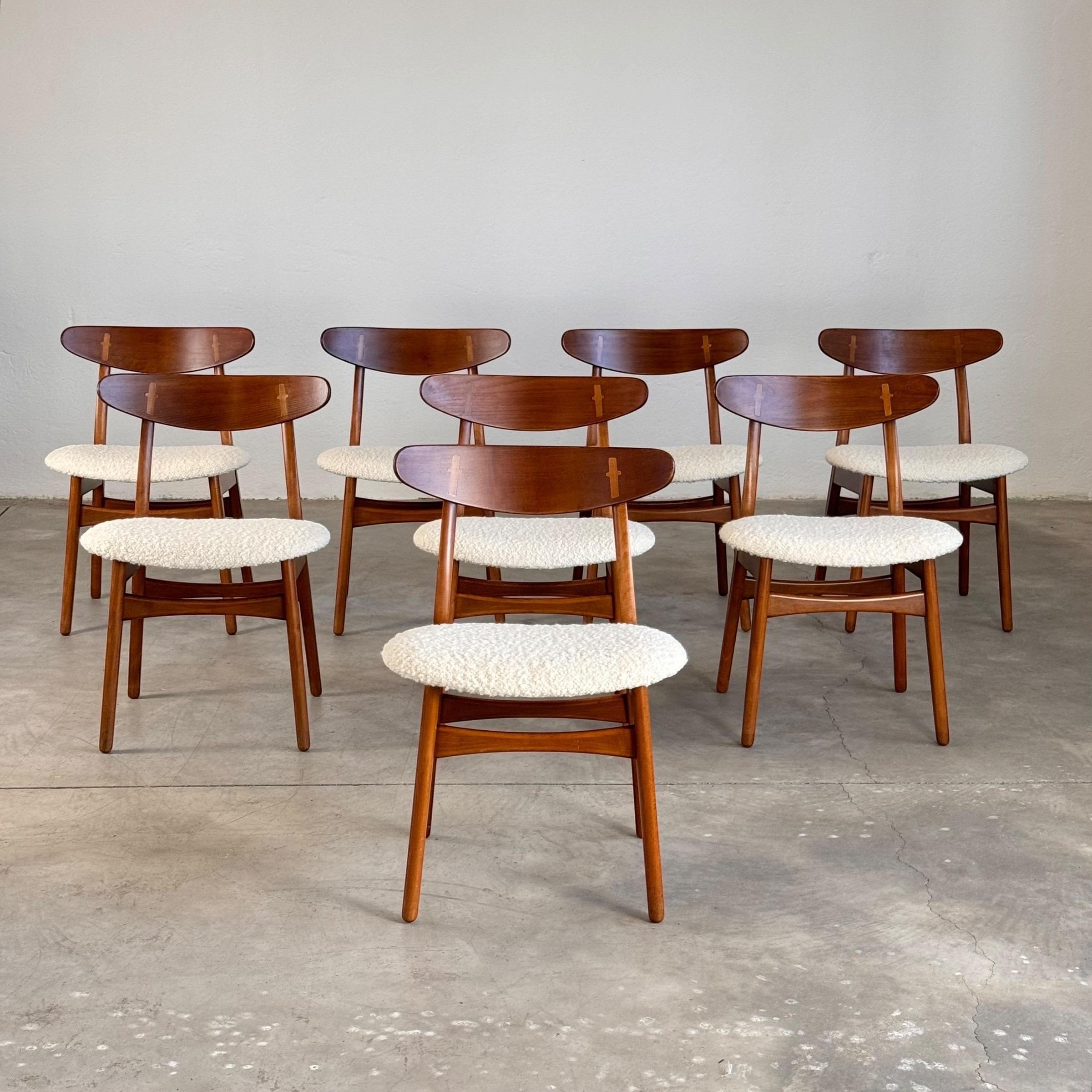 This stunning set of 8 dining chairs, designed by Hans J. Wegner in 1952 for Carl Hansen & Søn, embodies the essence of mid-century Scandinavian design. These early edition chairs feature the original burn-in impressed stamps, a testament to their