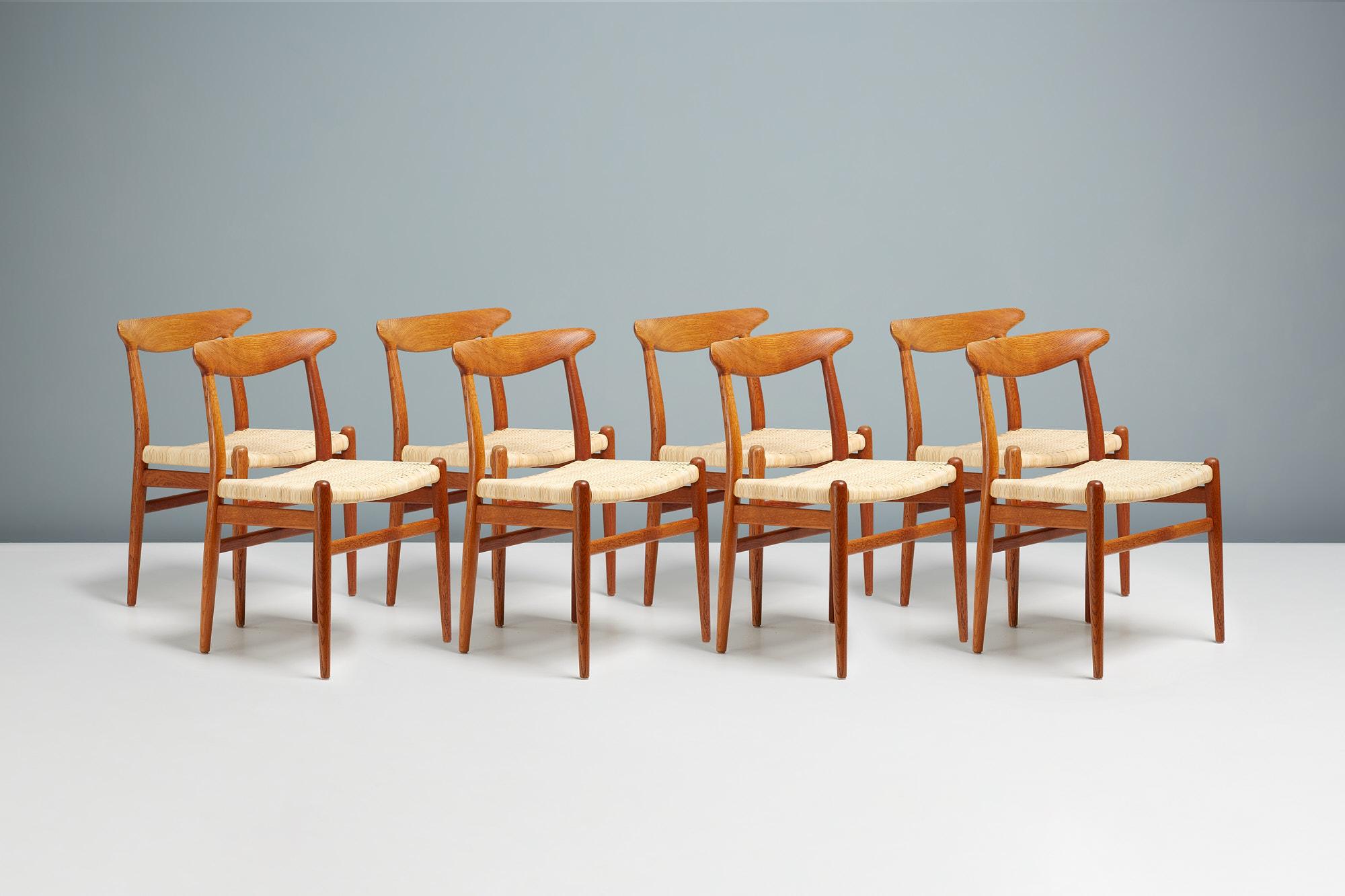 Hans Wegner - model w2 dining chairs 

Very rare set of 8 Model W2 dining chairs designed produced by C. M. Madsens in Denmark in 1953. Patinated, oiled ok frames with seats upholstered in woven rattan cane.