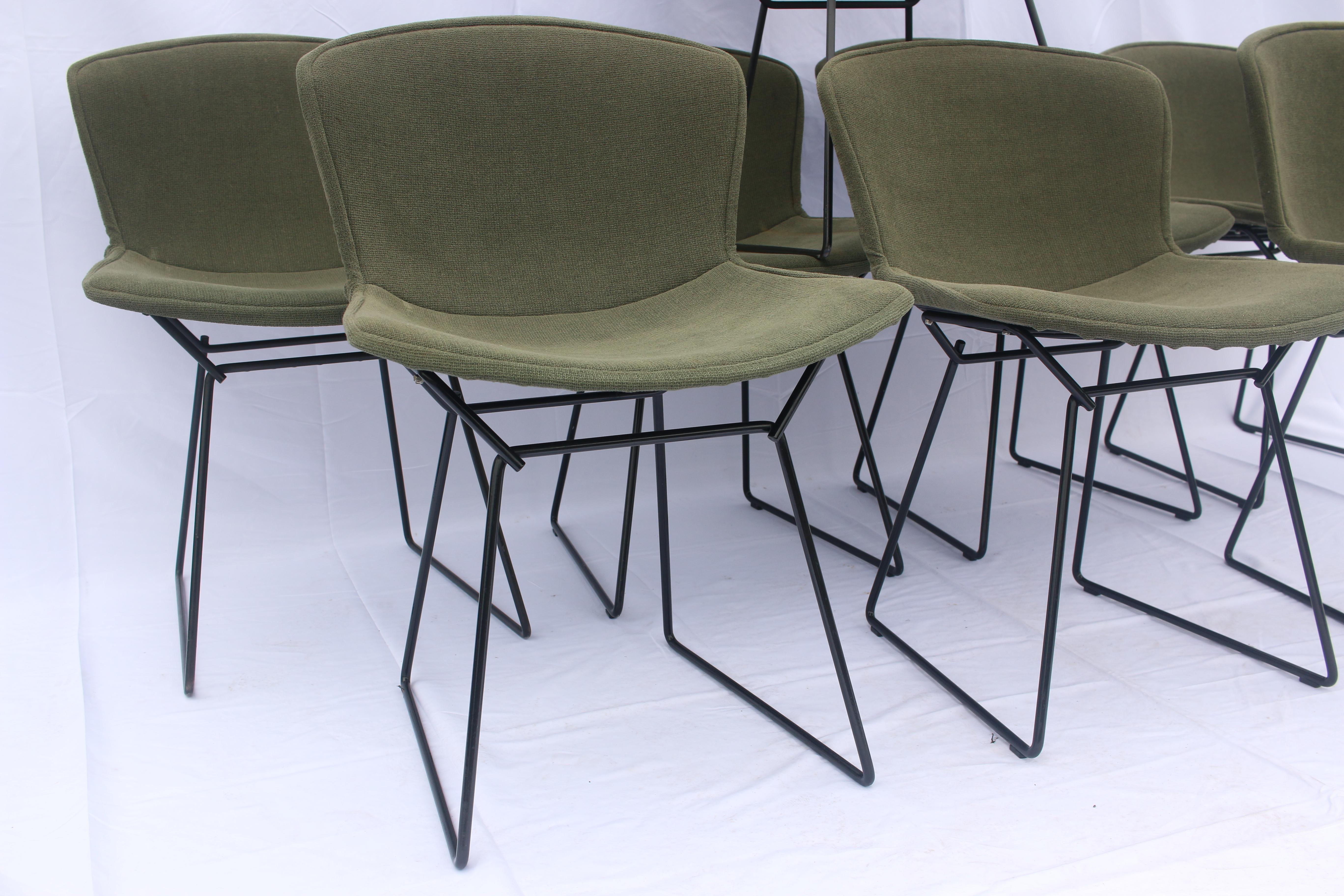 A set of 6 or 8 Harry Bertoia for Knoll black wire chairs with original green seat covers. In good vintage condition - structurally solid, some minor marks to the seat covers and some minor damage to the finish on a the feet of a couple of the