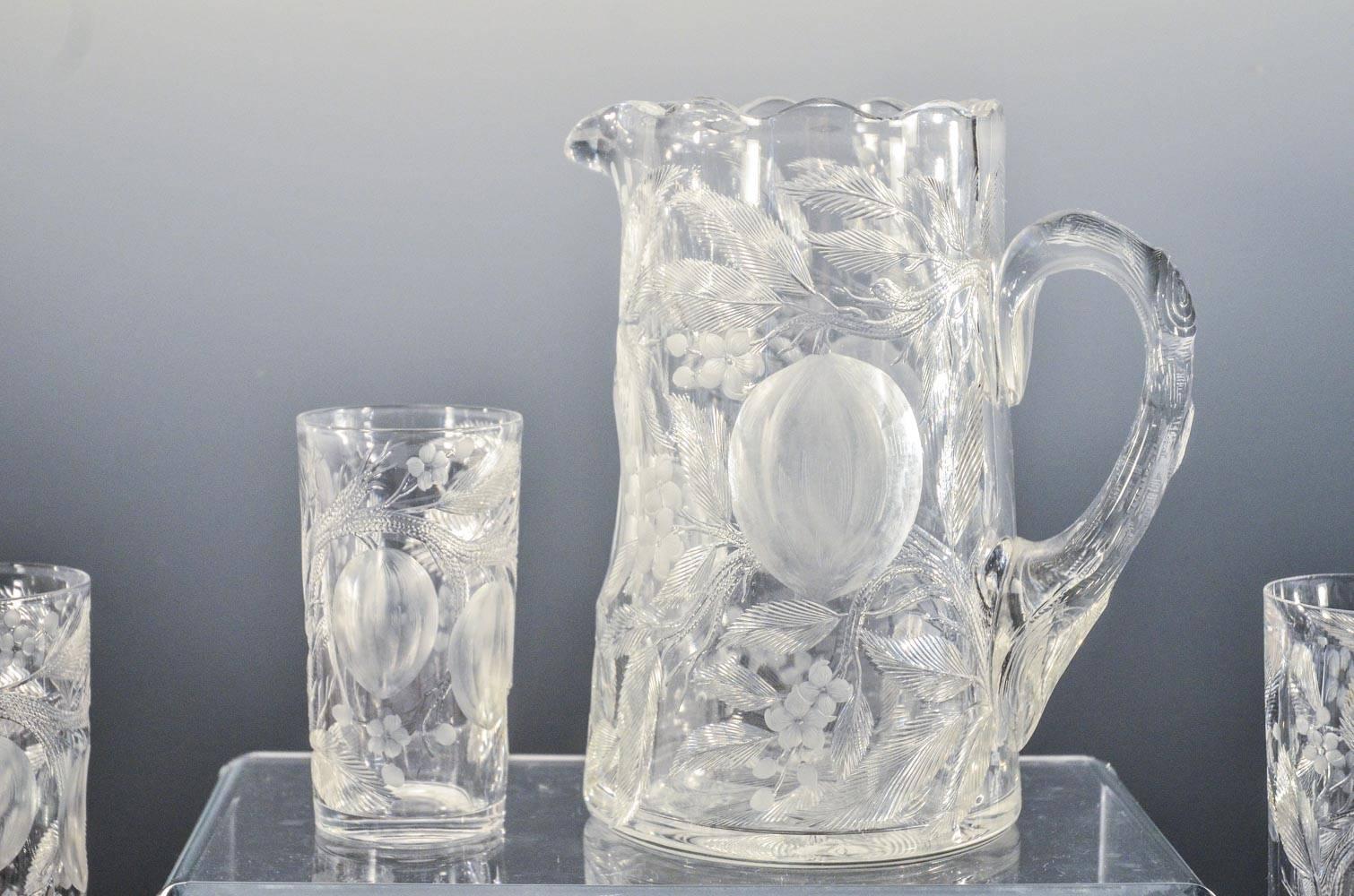 This is a rare set comprised of a fabulous signed Hawkes pitcher in the “Fruit Pattern” and 8 matching tumblers, measuring  4.75