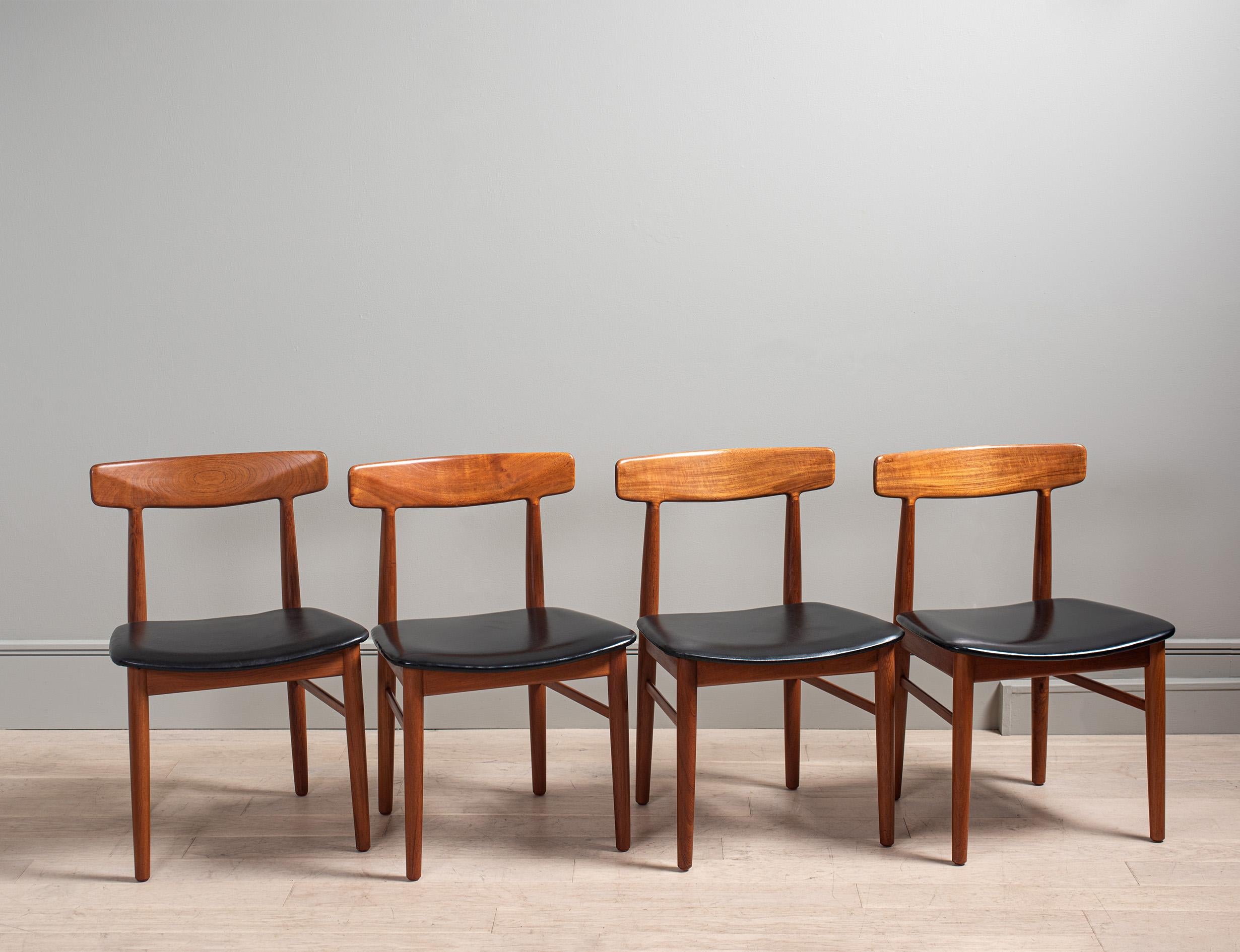 Unusual set of 8 solid teak dining chairs by Henning Kjaernulf, Bruno Hansen, Denmark circa 1950's. Superb design with sculpted and shaped angled back rests and black vinyl seats. Wonderfully coloured wood frames. Cleaned and polished