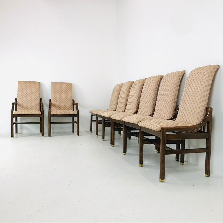 Set of 8 1970s dining chairs by Henredon. These sculptural chairs have a walnut frame with brass feet caps and floating seat frames. 2 armchairs and 6 side chairs. Solid and sturdy. Reupholstery is recommended.
Measures: Armchairs: 22.5