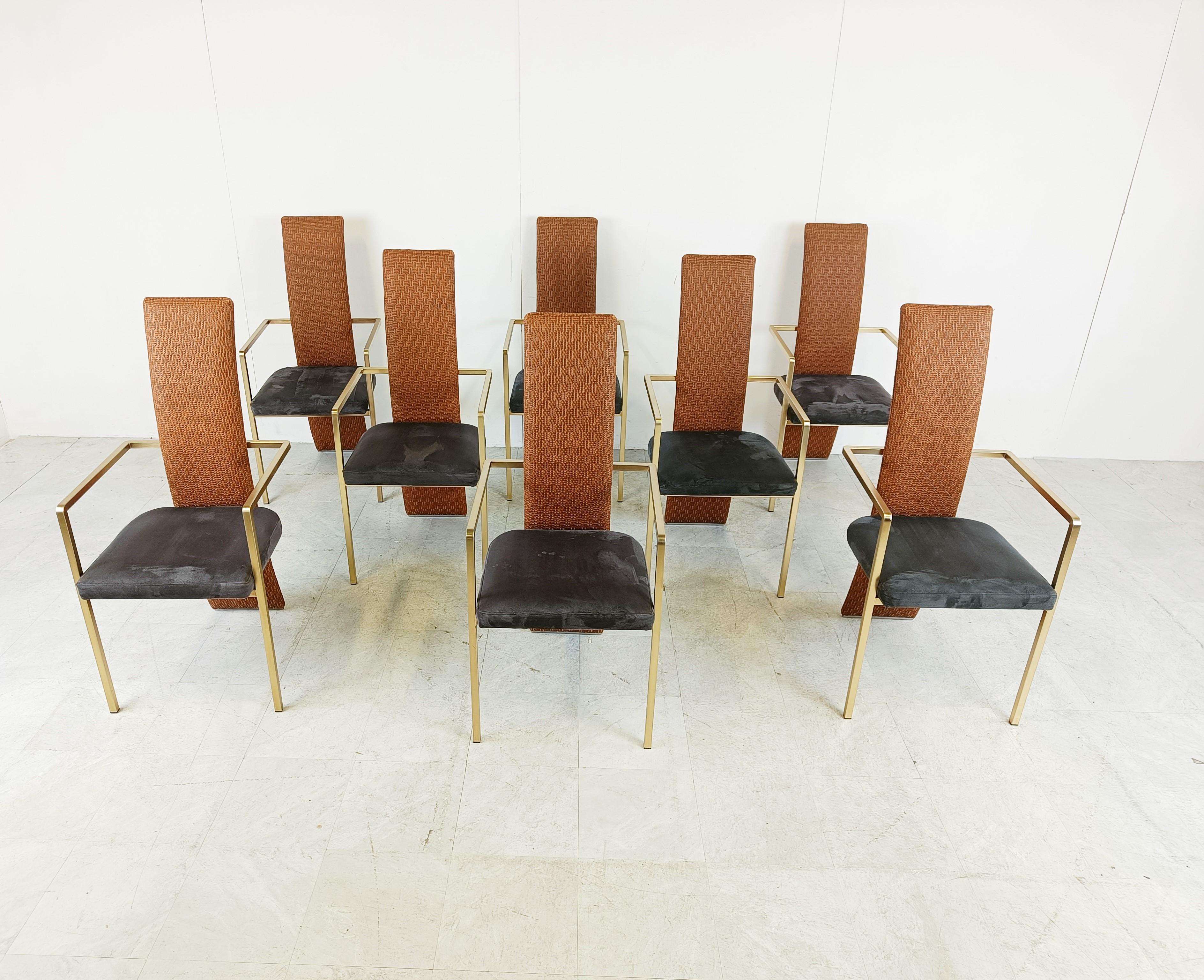 Set of eight elegant dining room chairs manufactured by Belgochrom.

The chairs are quite unique due to the wicker backrests and the dark blue alcantara seats.

Polished metal frames.

Belgochrom used to produce high end furniture and was the higher