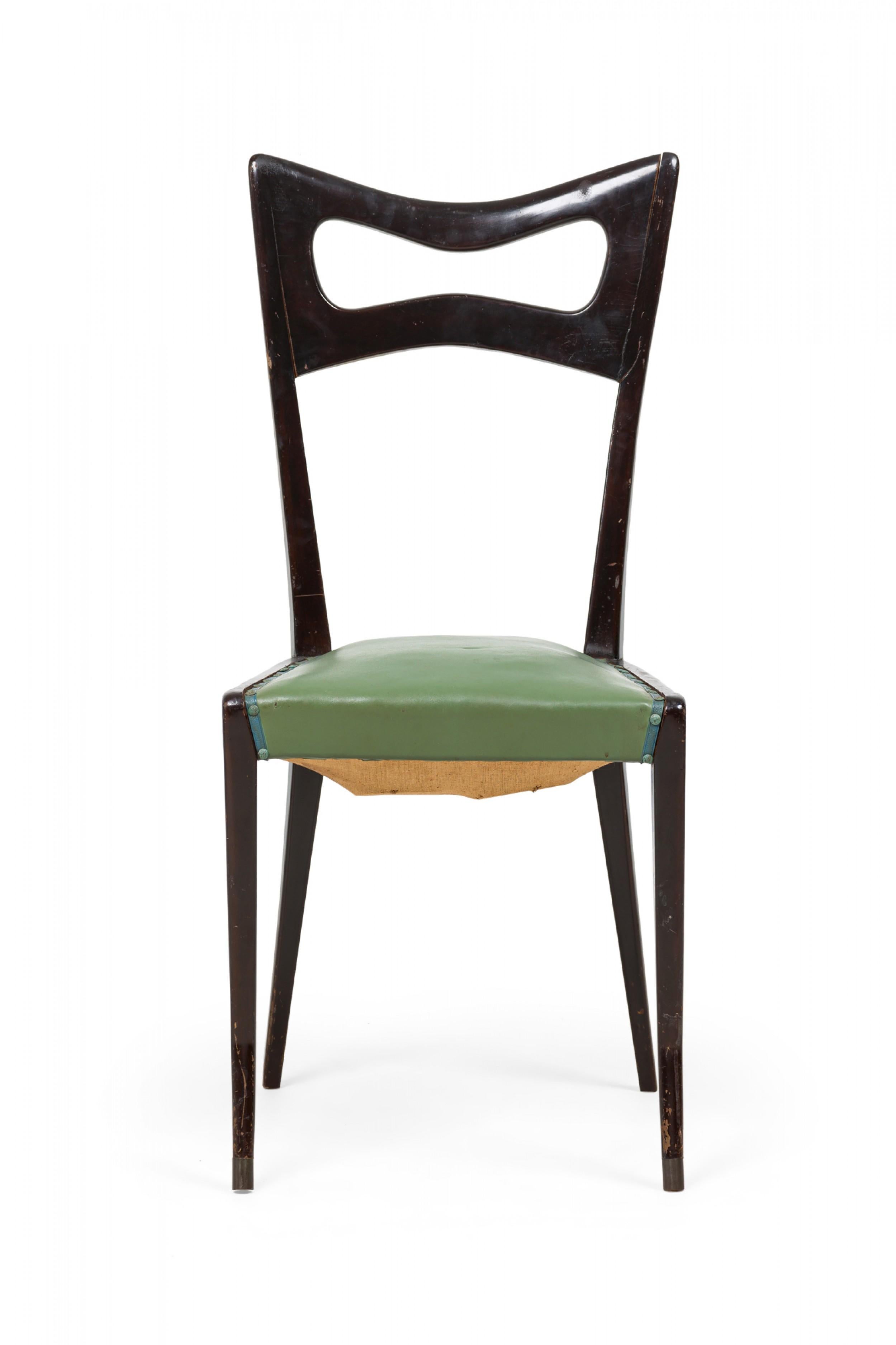 SET of 8 midcentury Italian dining chairs featuring ebonized frames with shaped openwork backrests, green leather upholstered seats and splayed front legs with a subtle angular sweep. (Ico Parisi) (PRICED AS SET).