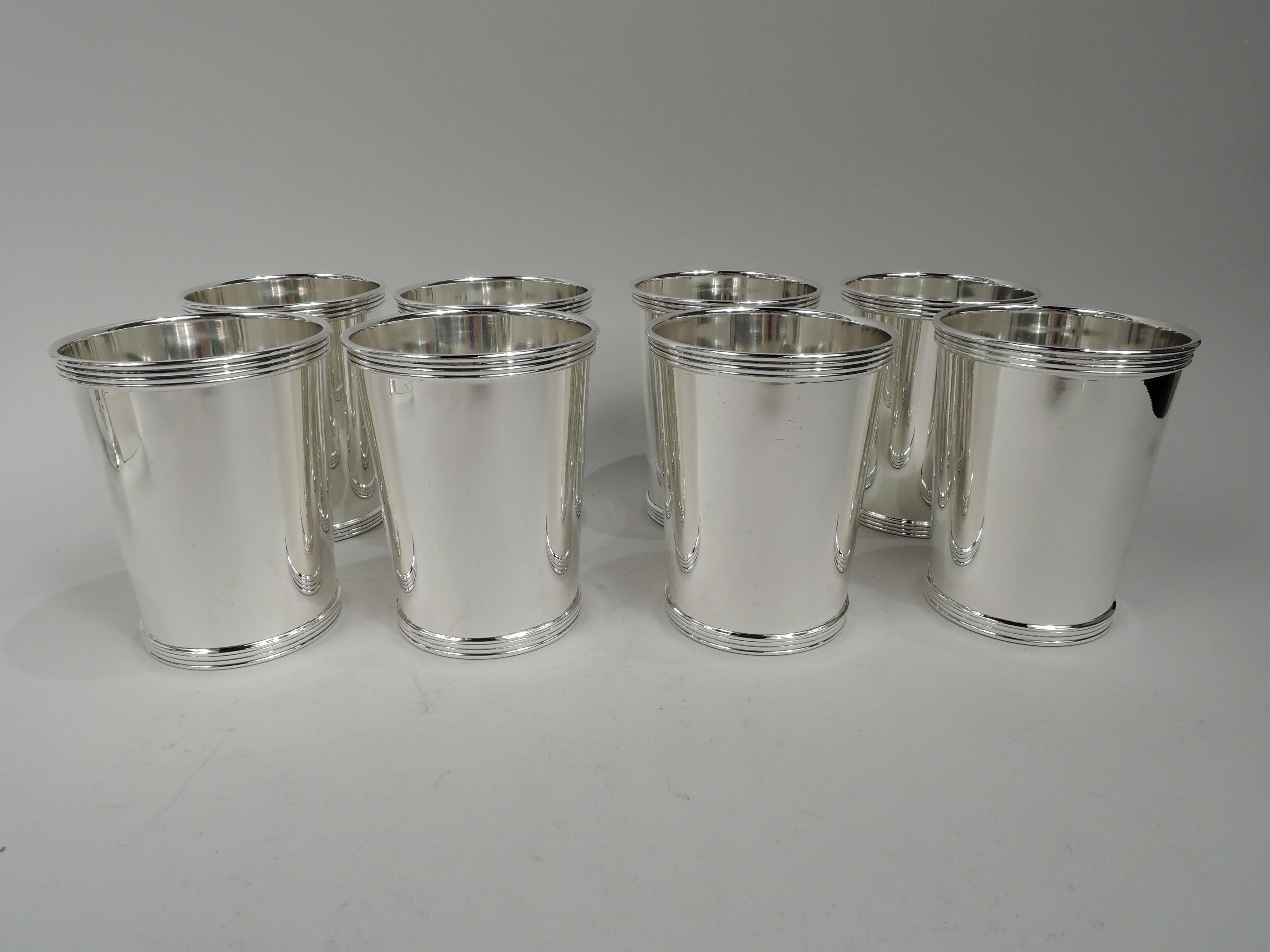 Set of 8 sterling silver mint julep cups. Made by International in Meriden, Conn. Each: Straight and tapering sides, and reeded rim and foot. Fully marked including maker’s stamp and no. P699. Total weight: 31 troy ounces.