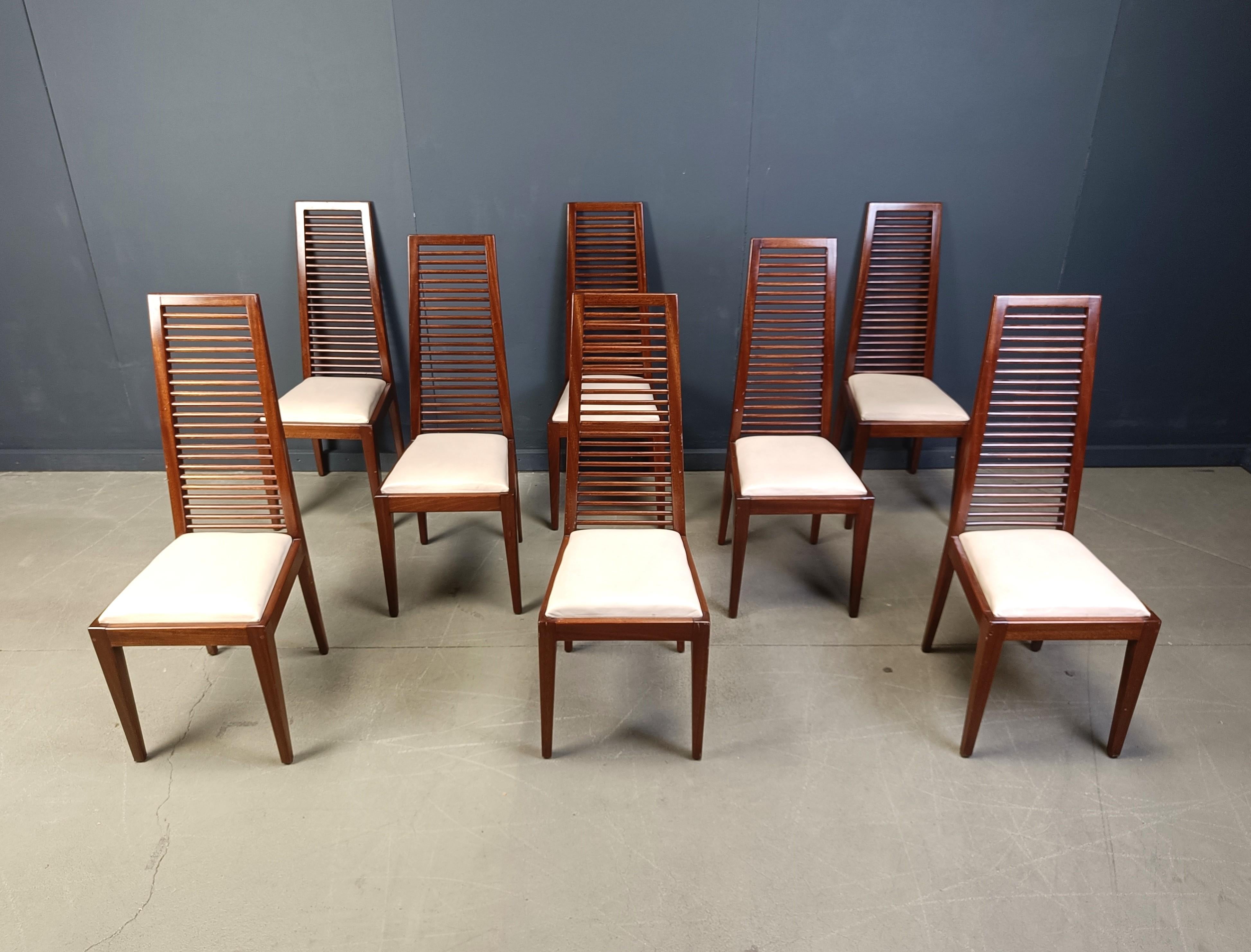 Elegant Italian dining chairs with ladder shaped high back rests. 

White faux leather seats create a nice contrast with the stained oak frames.

Beautiful, timeless and elegant design.

1980s - Italy

Good overall condition with normal age related