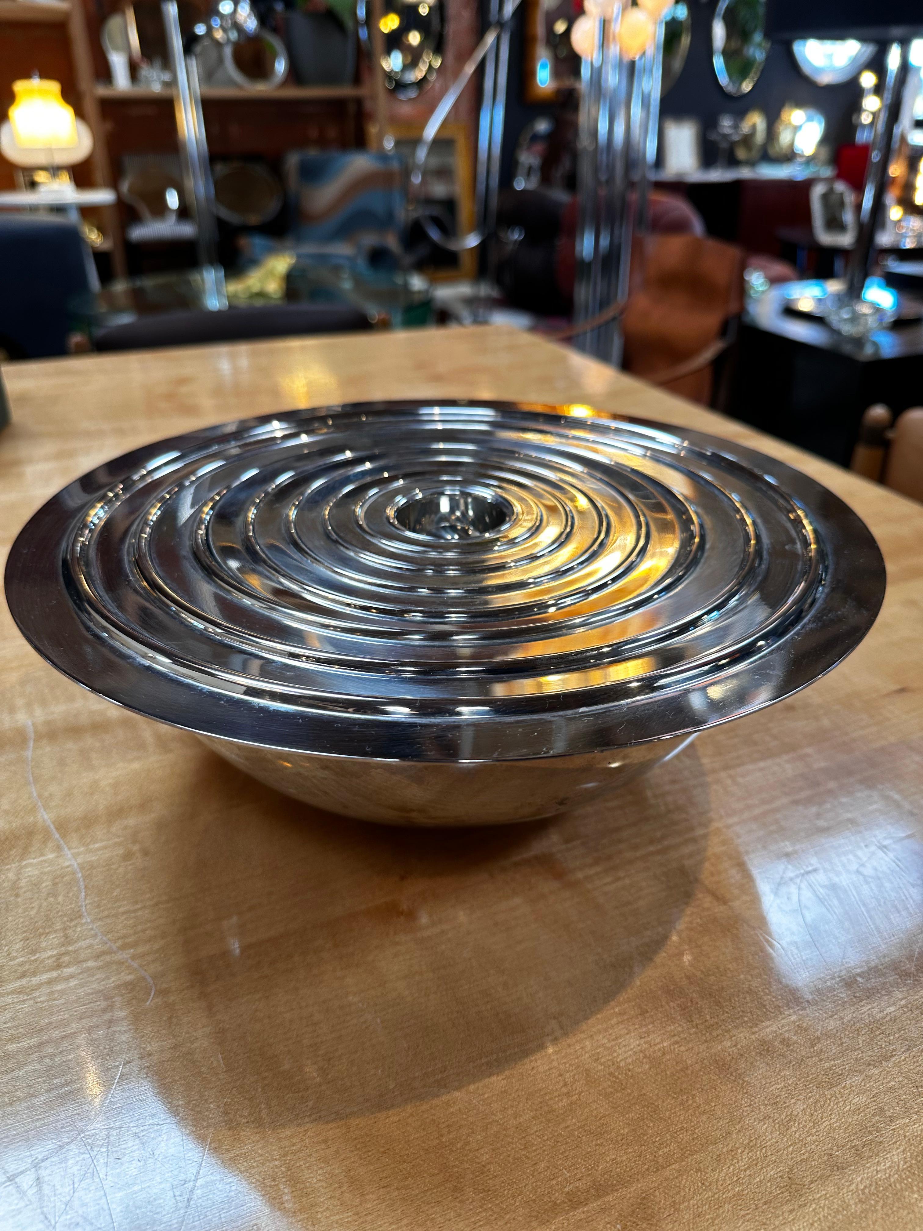The Set of 8 Italian Silver Decorative Bowls from the 1980s is a versatile and visually appealing collection. Crafted with silver, these decorative bowls showcase a stylish design that allows them to nest inside one another. This practical feature