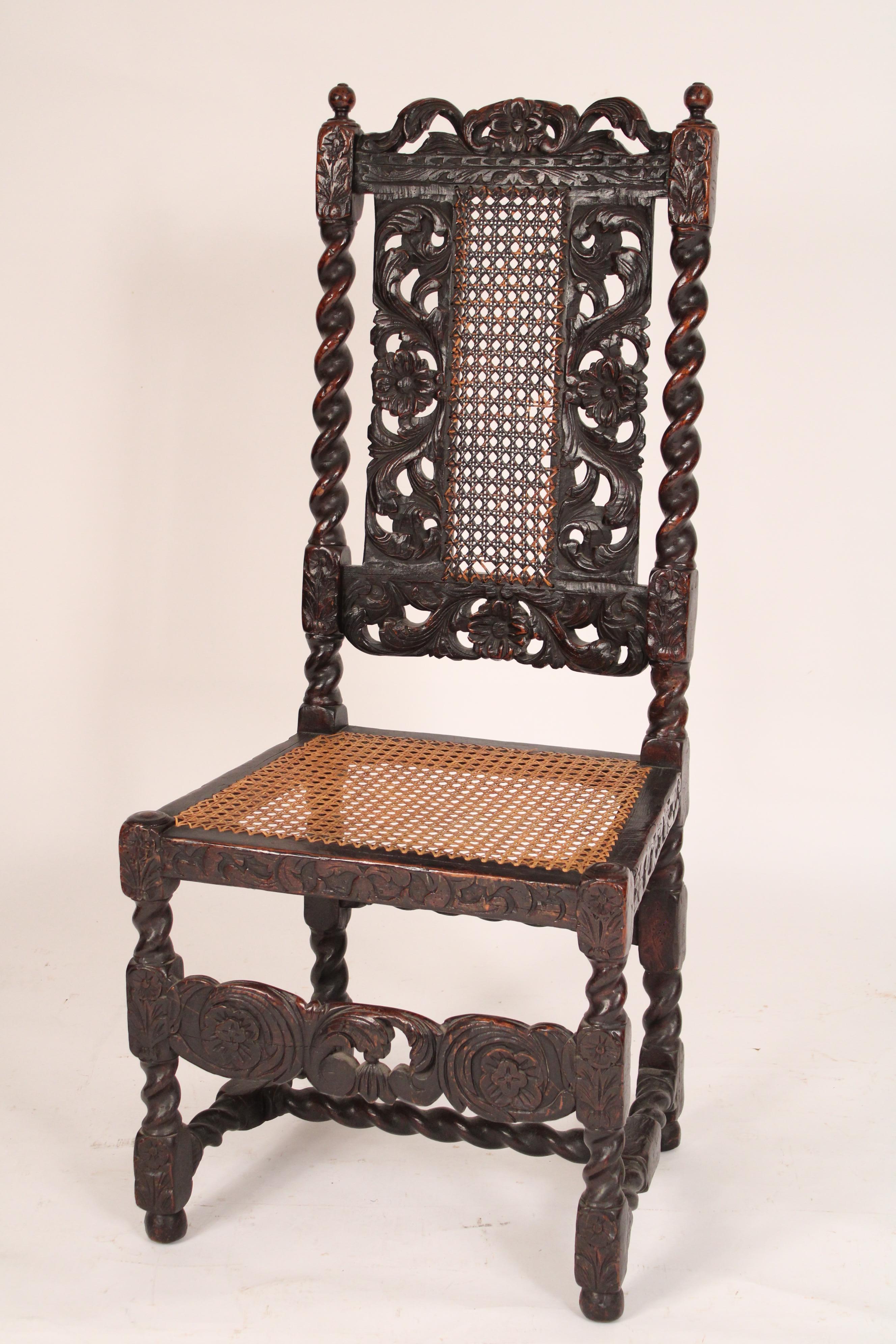 Set of 8 Jacobean Style Oak Dining Room Chairs, late 19th century. The crest rail with central carved Tudor rose flanked by vine carving, barley twist stiles, Tudor rose and vine carved back with inset cane panels, turned legs joined by barley twist