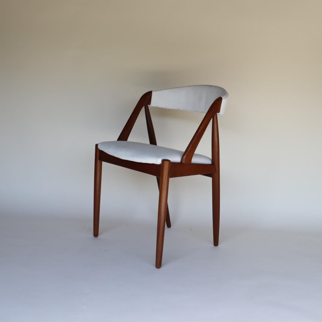 This set of 8 dining chairs were designed by Kai Kristiansen in 1956 and produced by Schou Andersen in the 1960's. This chair epitomizes the architectural ingenuity of Kai Kristensen. They are beautiful from all angles and very comfortable to sit
