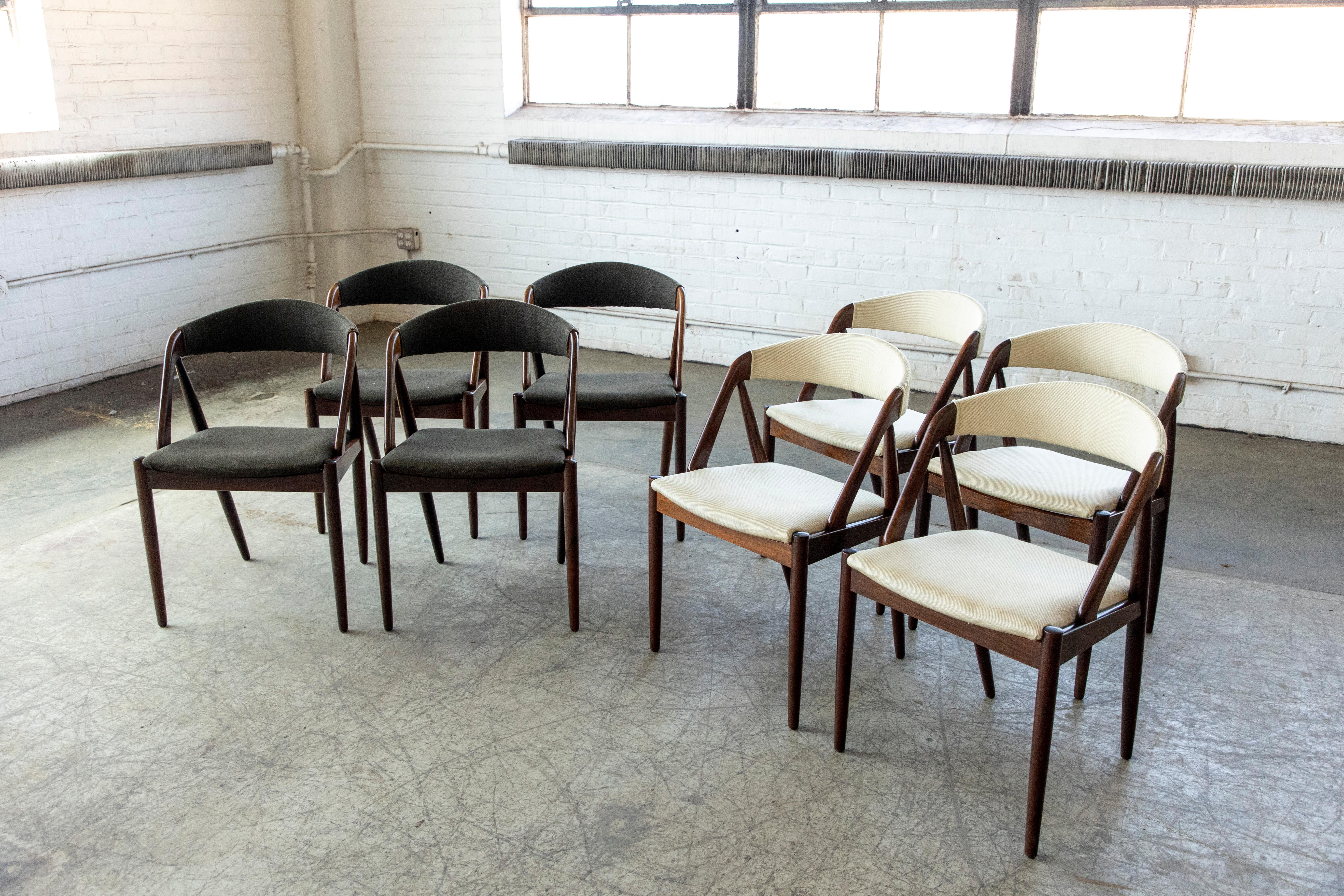 This set of eight dining room chairs model 31 in rosewood designed by Kai Kristiansen in 1956 and manufactured by Schou Andersen in the 1960s in Denmark. The chairs are made from rosewood and upholstered in various fabric wool fabric. Beautiful