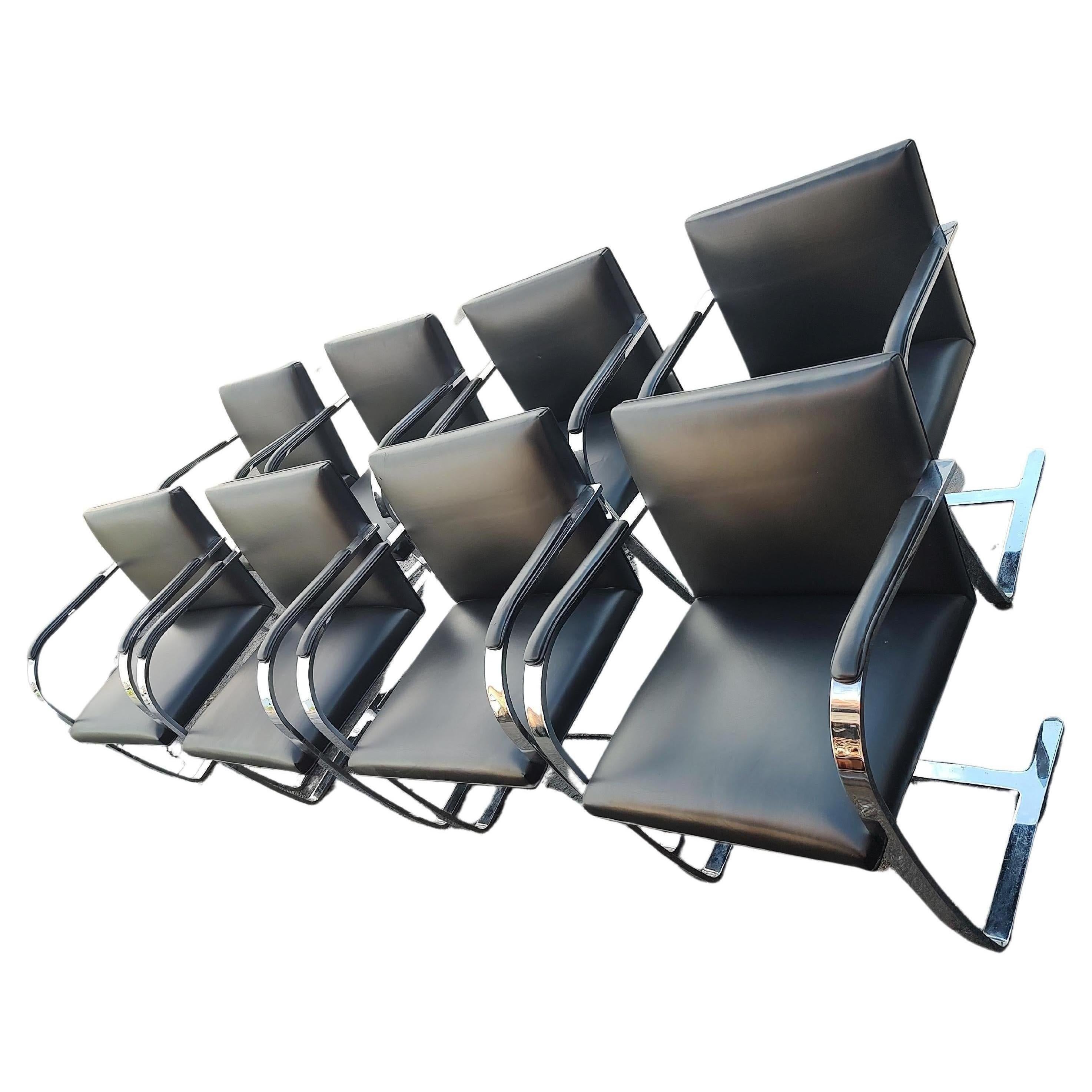 Fantastic set of 8 flat bar Brno chairs designed by Ludwig Mies van der Rohe in the twenties. Currently made and produced by Knoll Studio. All 8 are signed on the undersides of the chairs. Black Leather is in excellent vintage condition with minimal