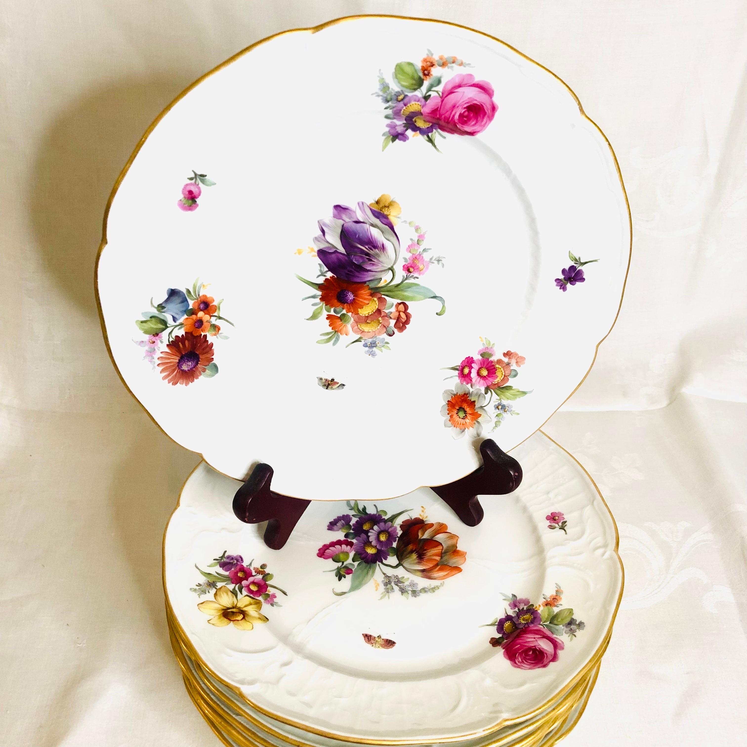 This is a gorgeous set of KPM luncheon or dessert plates. Each KPM plate has a different central bright colored bouquet of flowers. Each flower bouquet is masterfully painted by an extremely talented KPM artist. In addition to this beautiful central