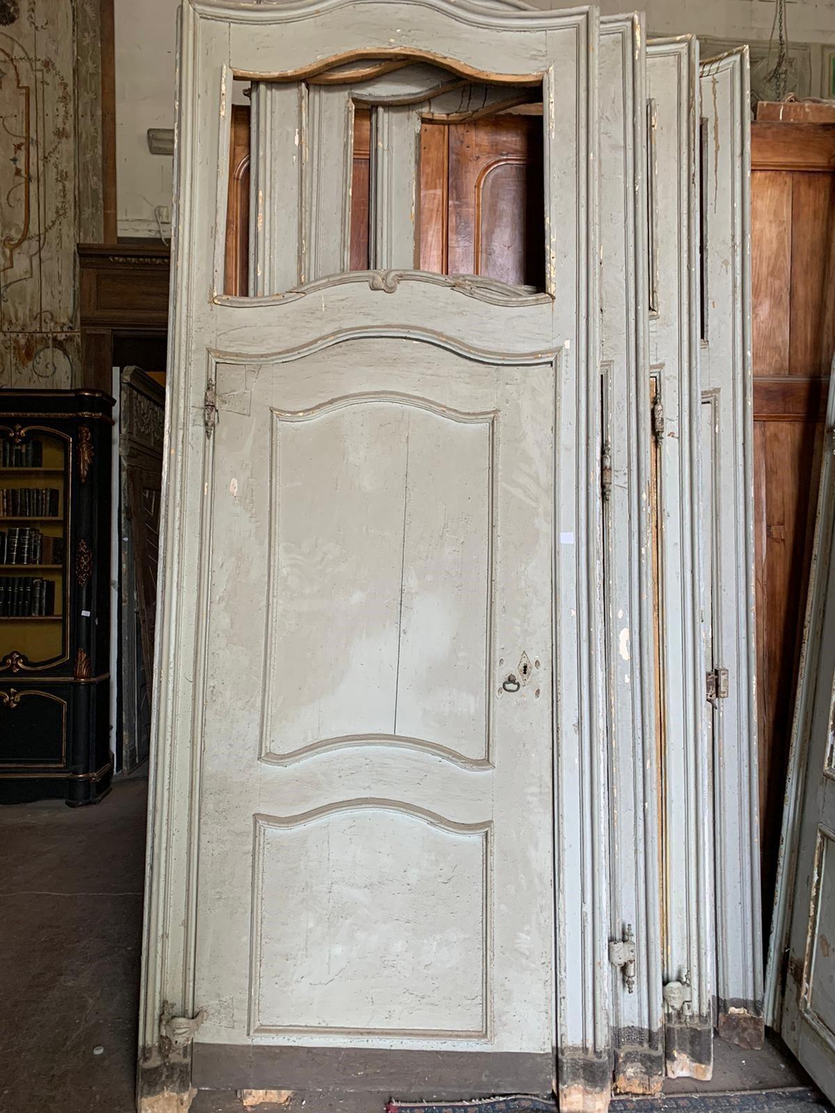 Incredible set of No. 8 antique interior doors, with frame and overdoor, are 4 with moved bar and 4 with straight bar, but coming from the same large noble residence in Piedmont (Italy). Hand-built in the 18th century, they have original gooseneck
