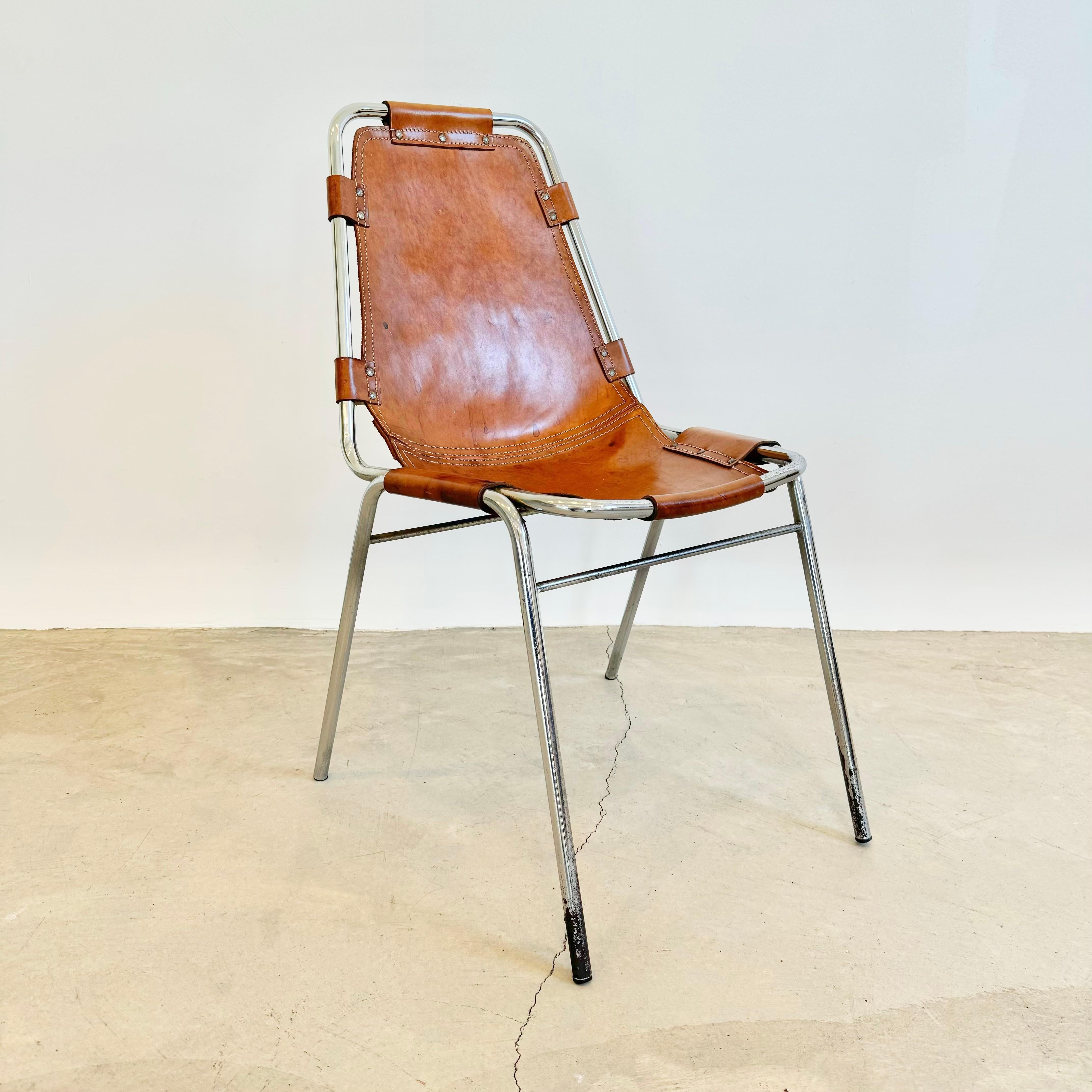 Stunning set of 8 dining chairs chosen by Charlotte Perriand for the Les Arcs ski resort. 1960s France. Superior example of chairs currently on the market. Tubular chrome frame with saddle leather held by rivets. Great condition to chrome. Fantastic