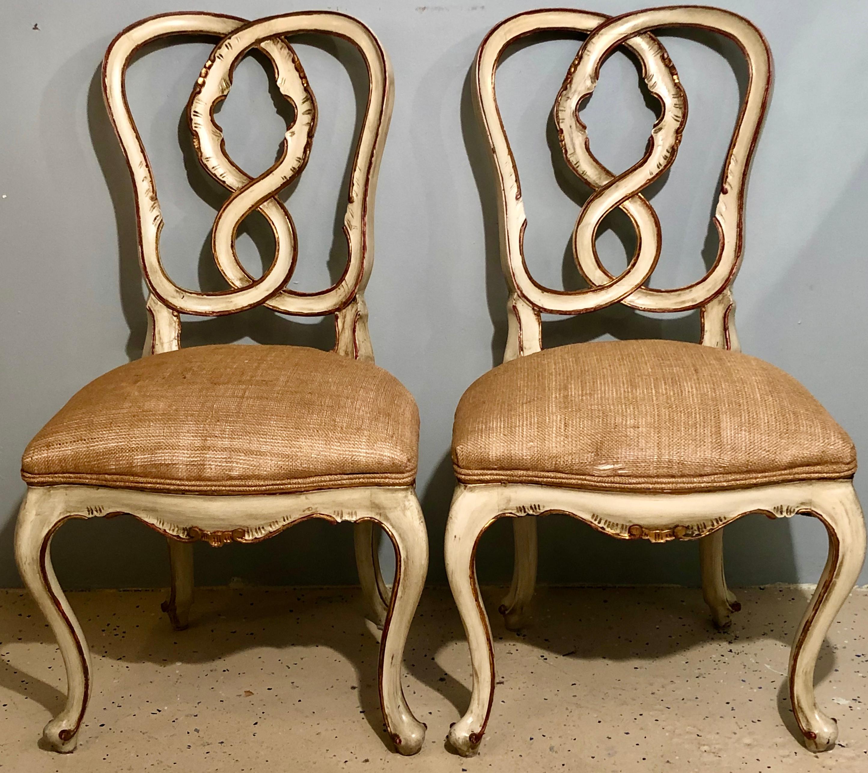 Set of eight Louis XV style dining chairs. A spectacular parcel-gilt and paint decorated pretzel heart back set of solid dining chairs direct from a Rowayton CT home. This fine set of dining chairs in the manner of Maison Jansen are finely paint