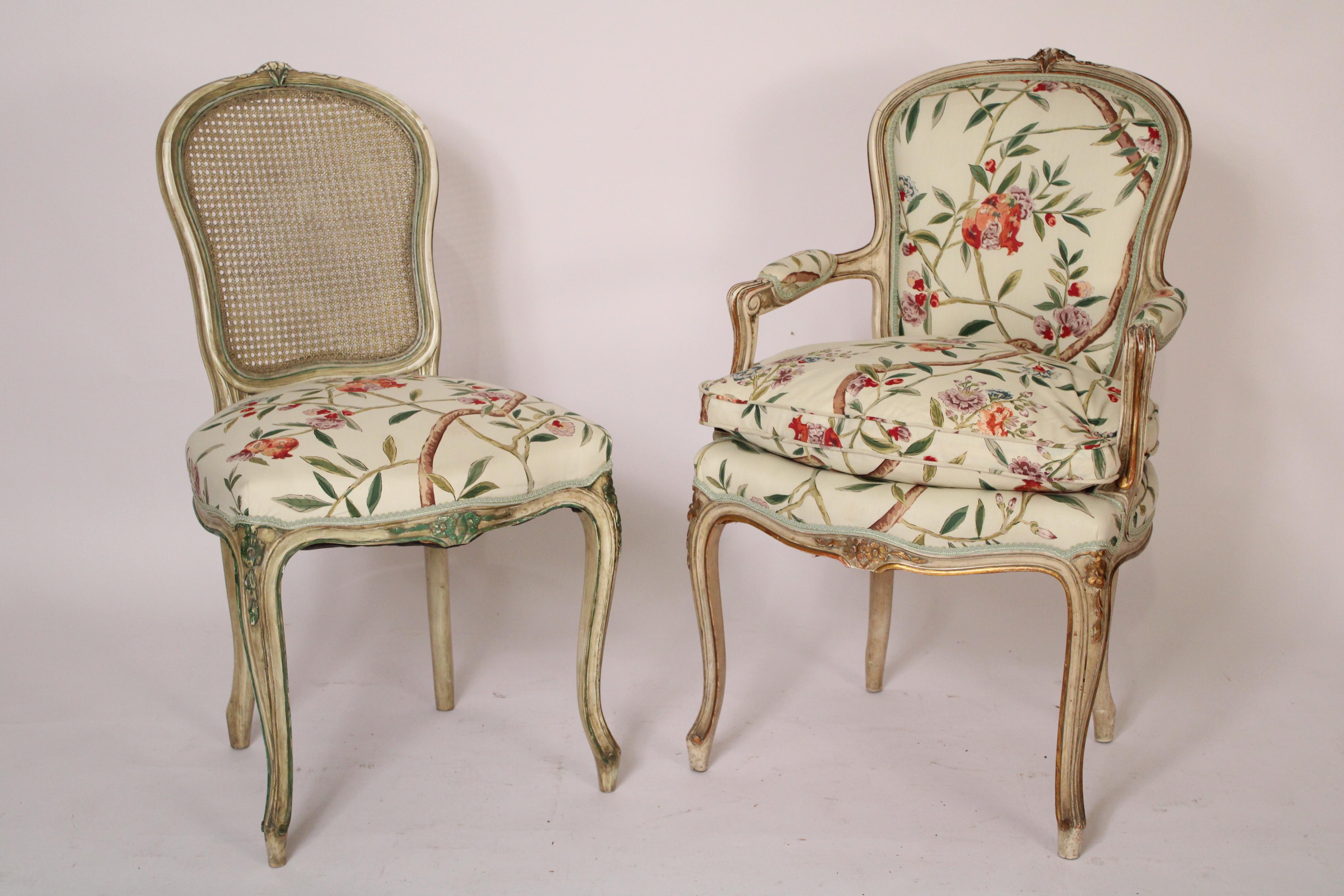 Set of 8 Louis XV style painted dining room chairs, circa 1960's. With rounded crest rails with central floral carving, cane backs, floral upholstered seats, armchairs with partial down filled seats, resting on cabriole legs. Dimensions of