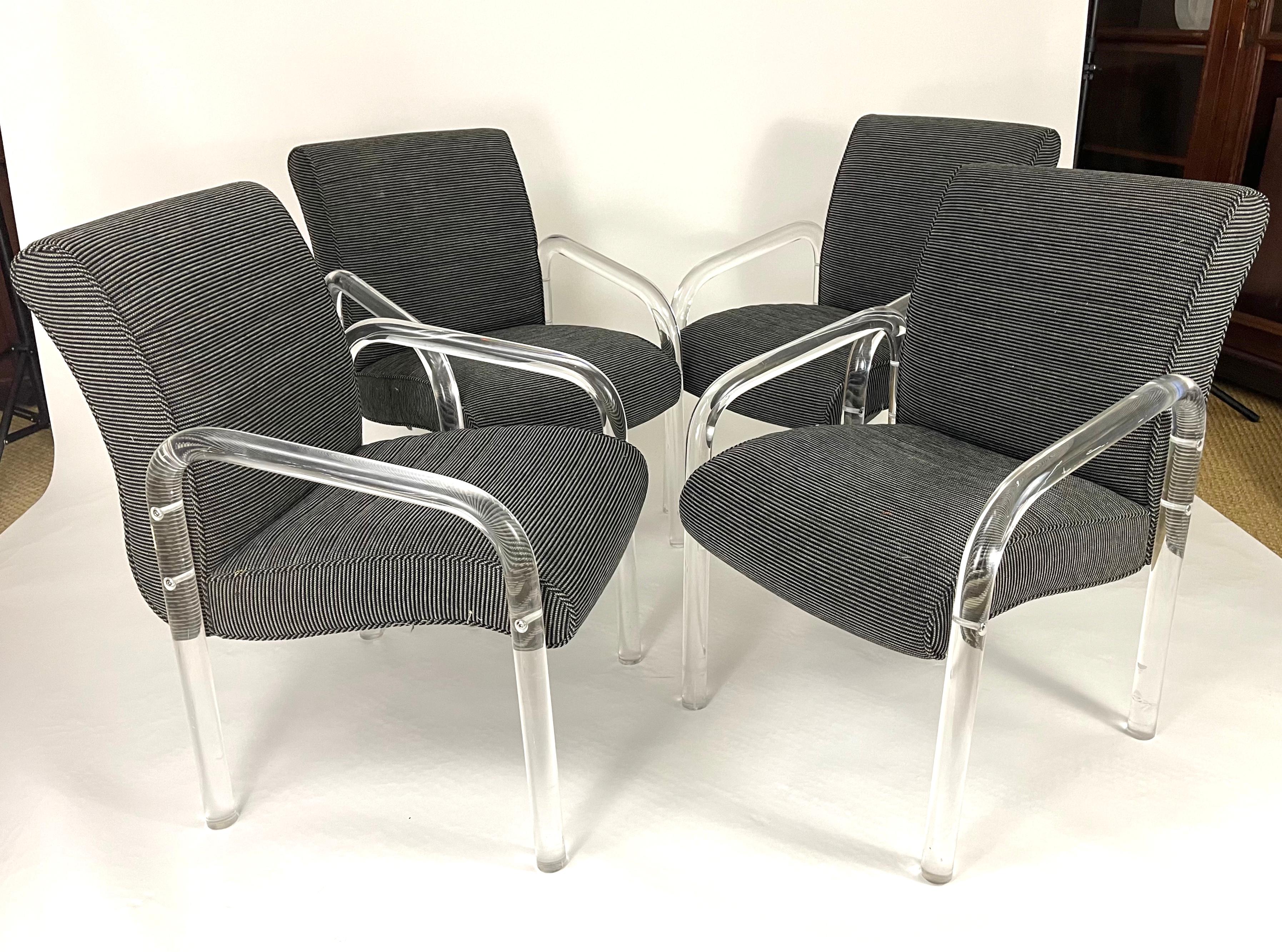 Set of 8 clear acrylic, lucite, dining arm chairs made by Lion and Frost, in their immaculate original grey and black striped upholstery fabric. Very sturdy, well made and comfortable. Each chair is signed on the rear right leg with an etched