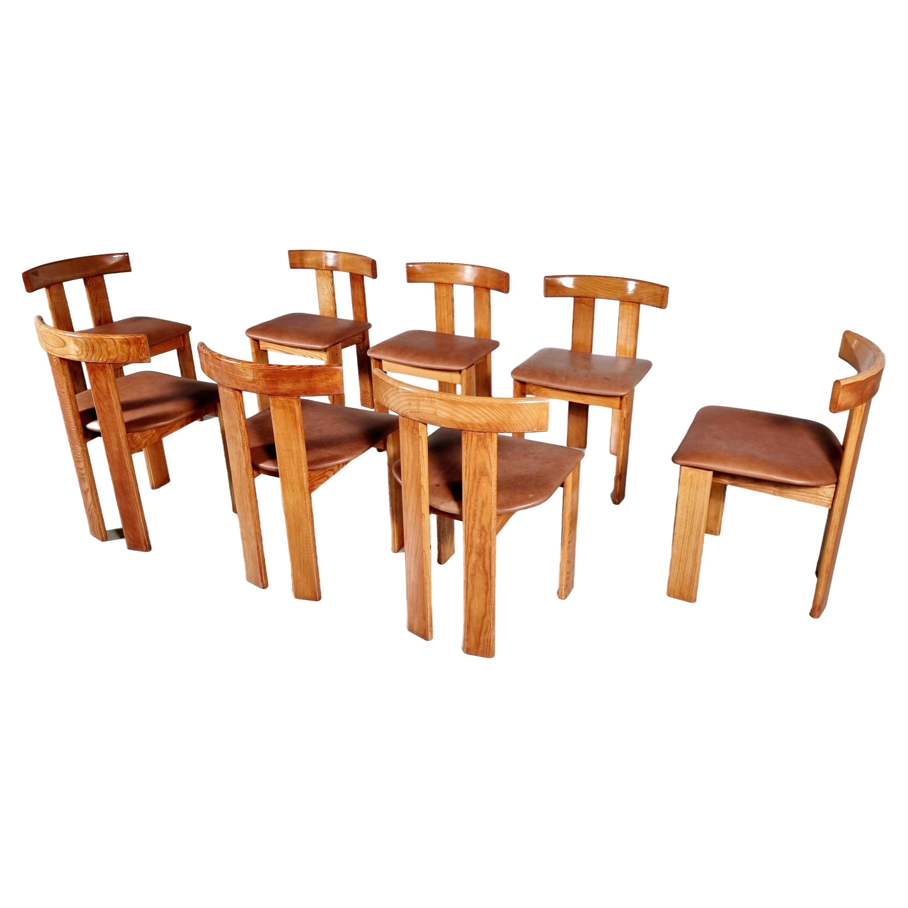 Set of 8 dining chairs by Luigi Vaghi for Former, 1960s.  

Beautiful set of 8 'T-chair' dining chairs in stained ash and cognac leather upholstery. Simplistic yet very strong in lines and proportions. Wonderful frame executed in dark stained ash,