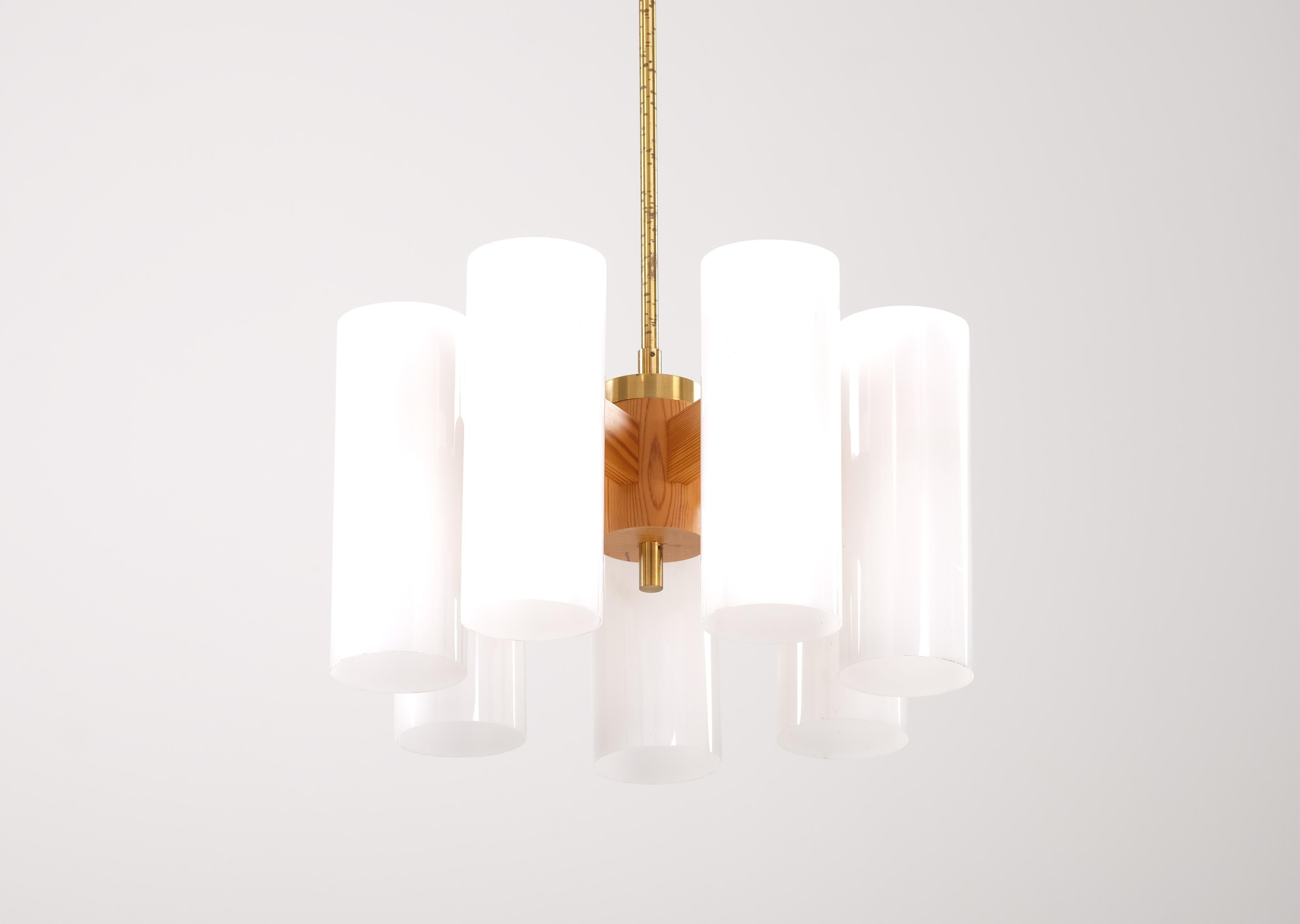 Uno & Östen Kristiansson chandeliers produced by Luxus. Solid pine, brass and acrylic shades. 
Height is adjustable after your preferences.
Please note: Listed price is for one (1) lamp.