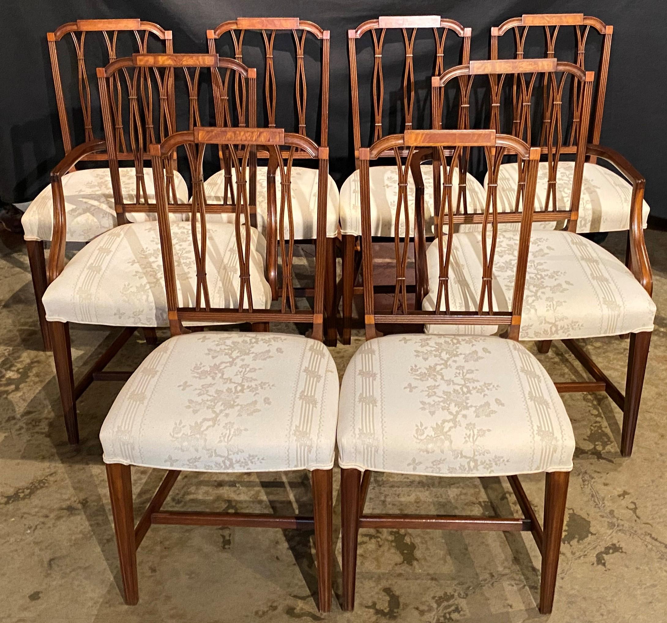 A fine set of eight mahogany Federal style upholstered dining chairs including two arm chairs and six side chairs, with stepped crest rail on each chair with inlaid panel, reticulated splats, floral cream color upholstery, all supported by H form