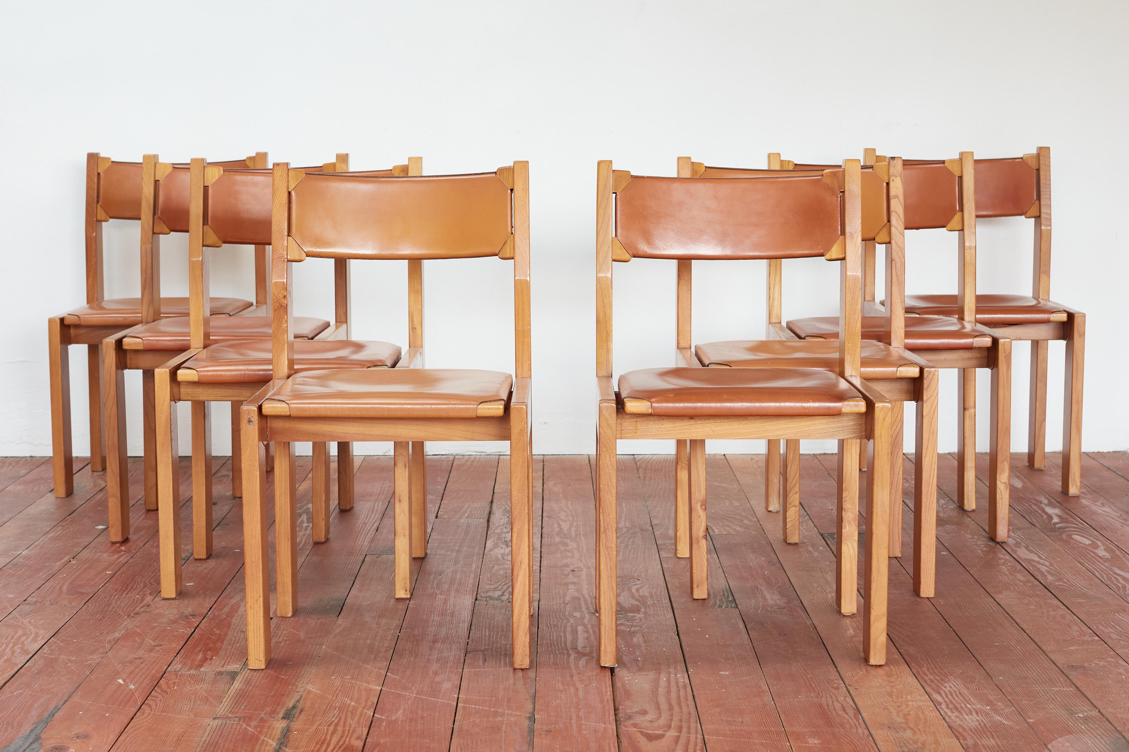 Maison Regain leather and elm wood chairs with cushioned seats. 

Great patina to leather and solid construction in the style of Pierre Chapo.

France 1960's.

Sold as a set of 8.