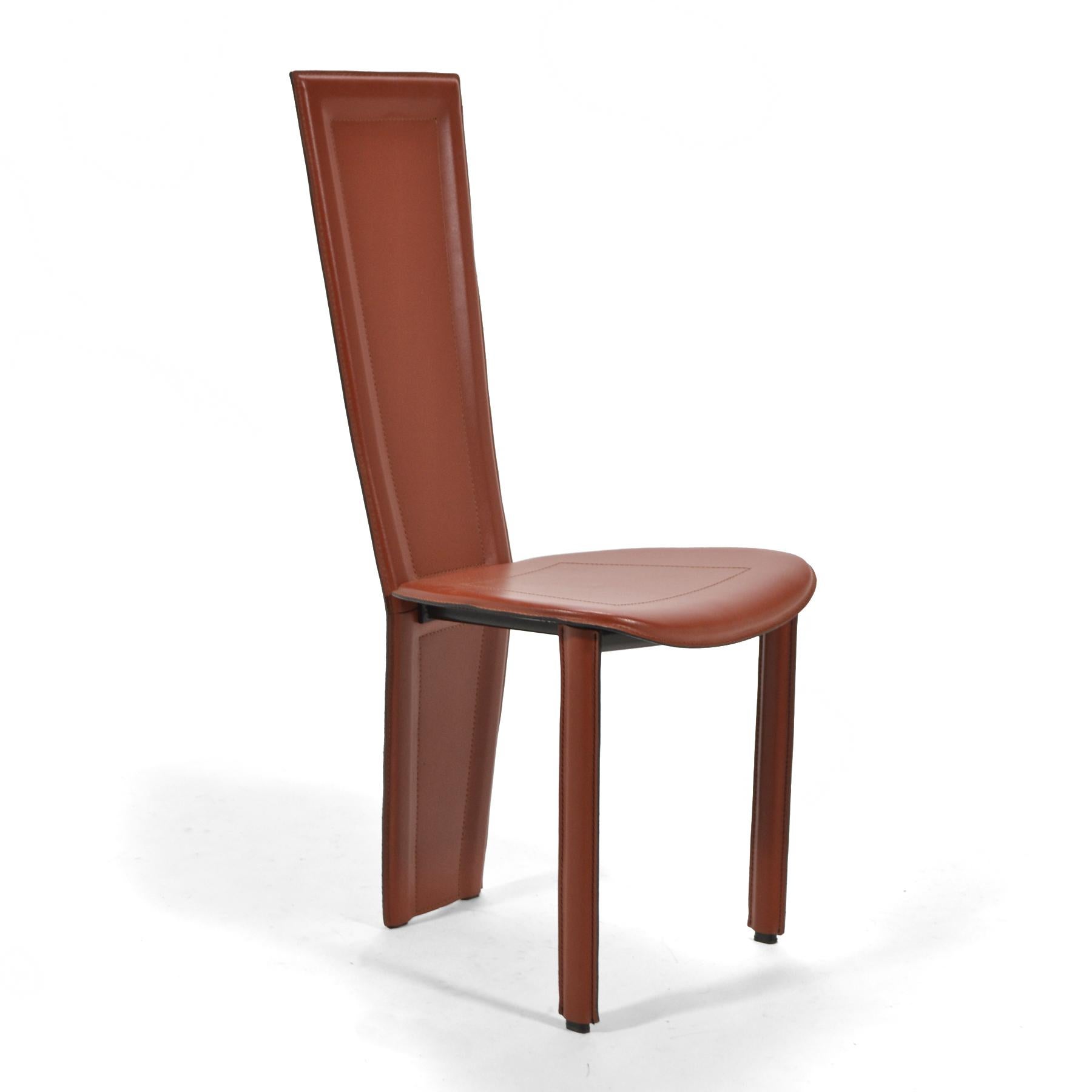 Italian high-style post-modern design, these eight sienna colored leather chairs are elegant and uncommon. Possibly designed by Pietro Costantini, the chairs share qualities with designs by Frank Lloyd Wright and Mario Bellini. The chairs have steel