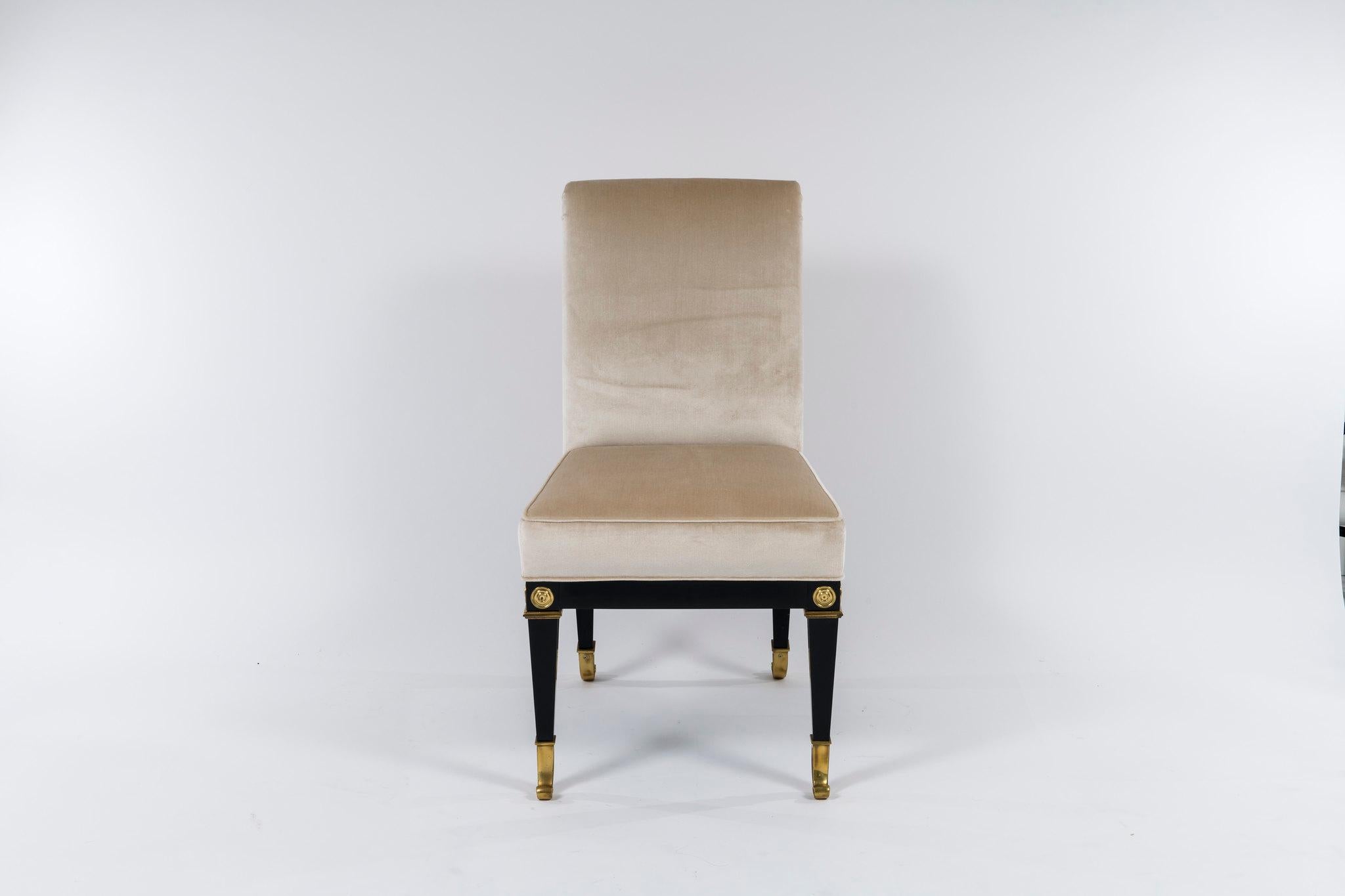 Set of 8 vintage Mastercraft Neoclassical style dining chairs. These ebonized chairs with bronze sabots have been newly modified and professionally upholstered in a Champagne Donghia silk velvet

Dimensions:
Side chair 21