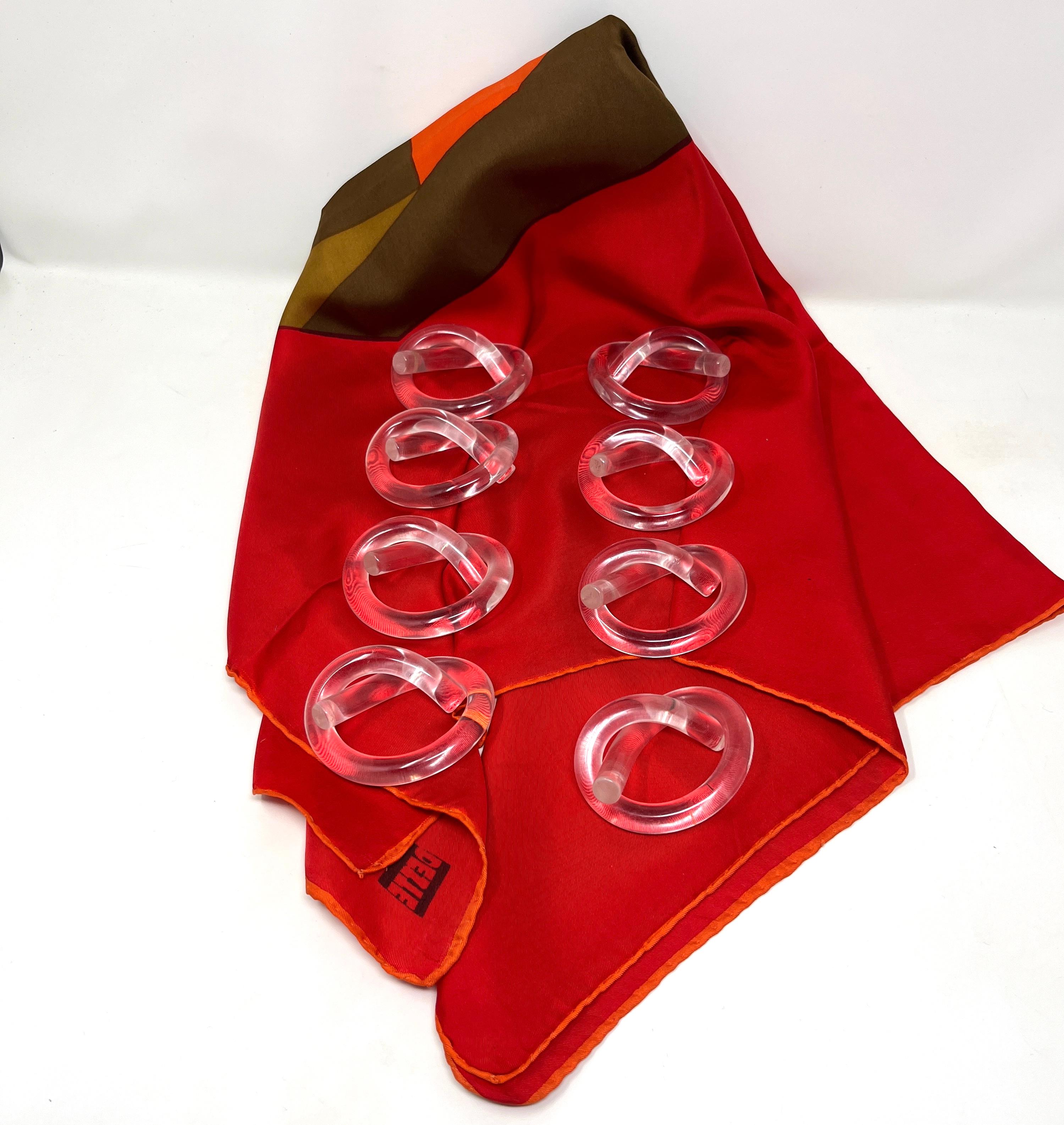 Set of 8 mid-century modern Lucite pretzel-shaped napkin rings designed by Dorothy Thorpe. Single tubes of solid Lucite are wrapped into a pretzel-like form as ideal napkin rings. They can also be used as utensil rests. 

Very good to excellent