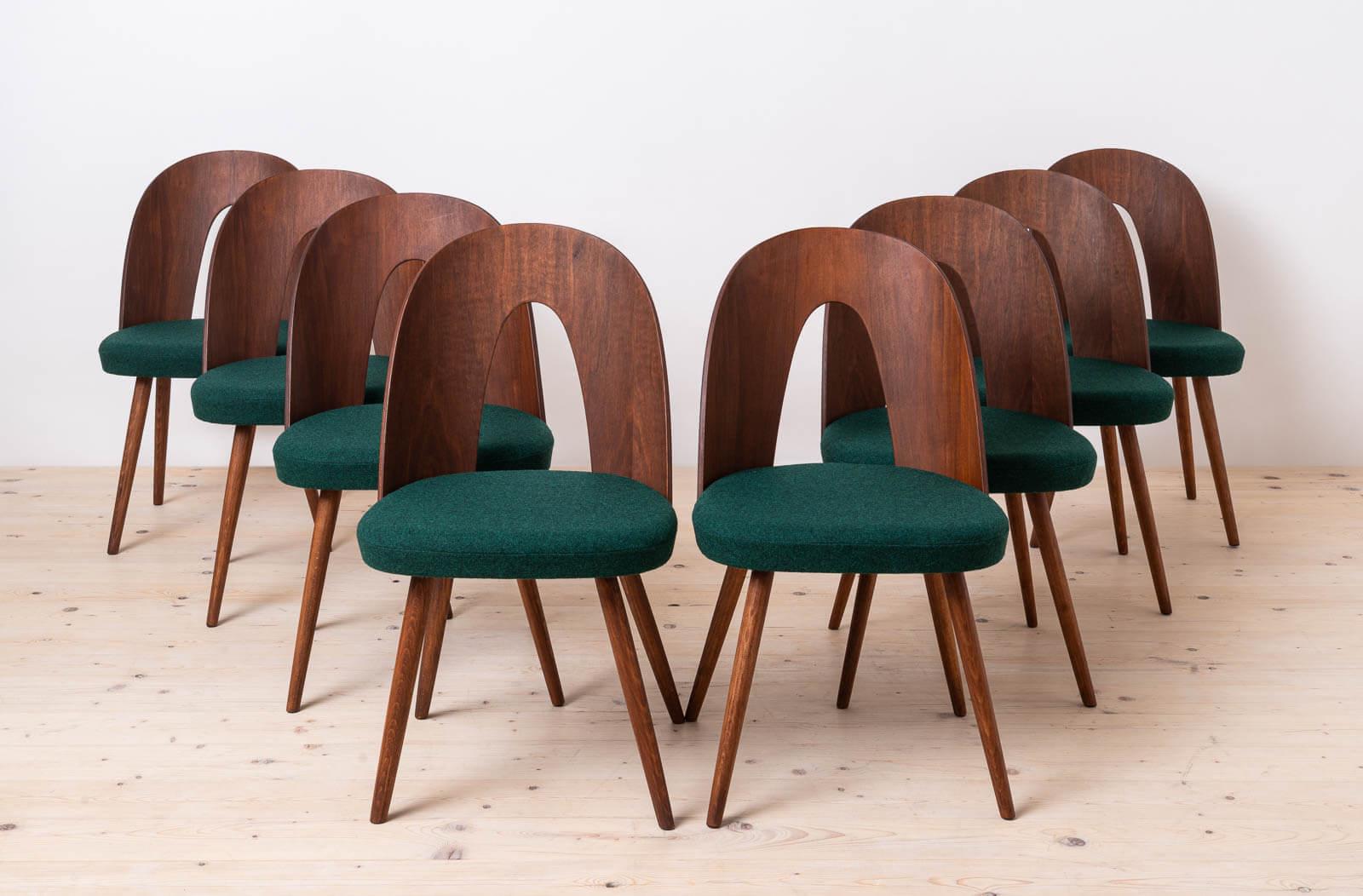 This set of eight vintage dining chairs was designed by Czech designer Antonin Šuman in the 1960s. The chairs have been completely restored, stained to chocolate brown color to even out the whole set, finished with high-quality oil that gave them