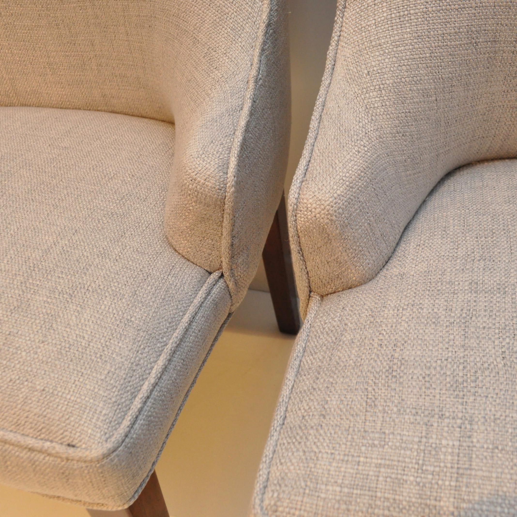 Vintage 1950S-era set of high back upholstered chairs featuring two tall back end chairs and six lower high backs, all newly upholstered in light gray linen. The previous upholsters label had a date of 1966. On one leg of each chair, near the seat's