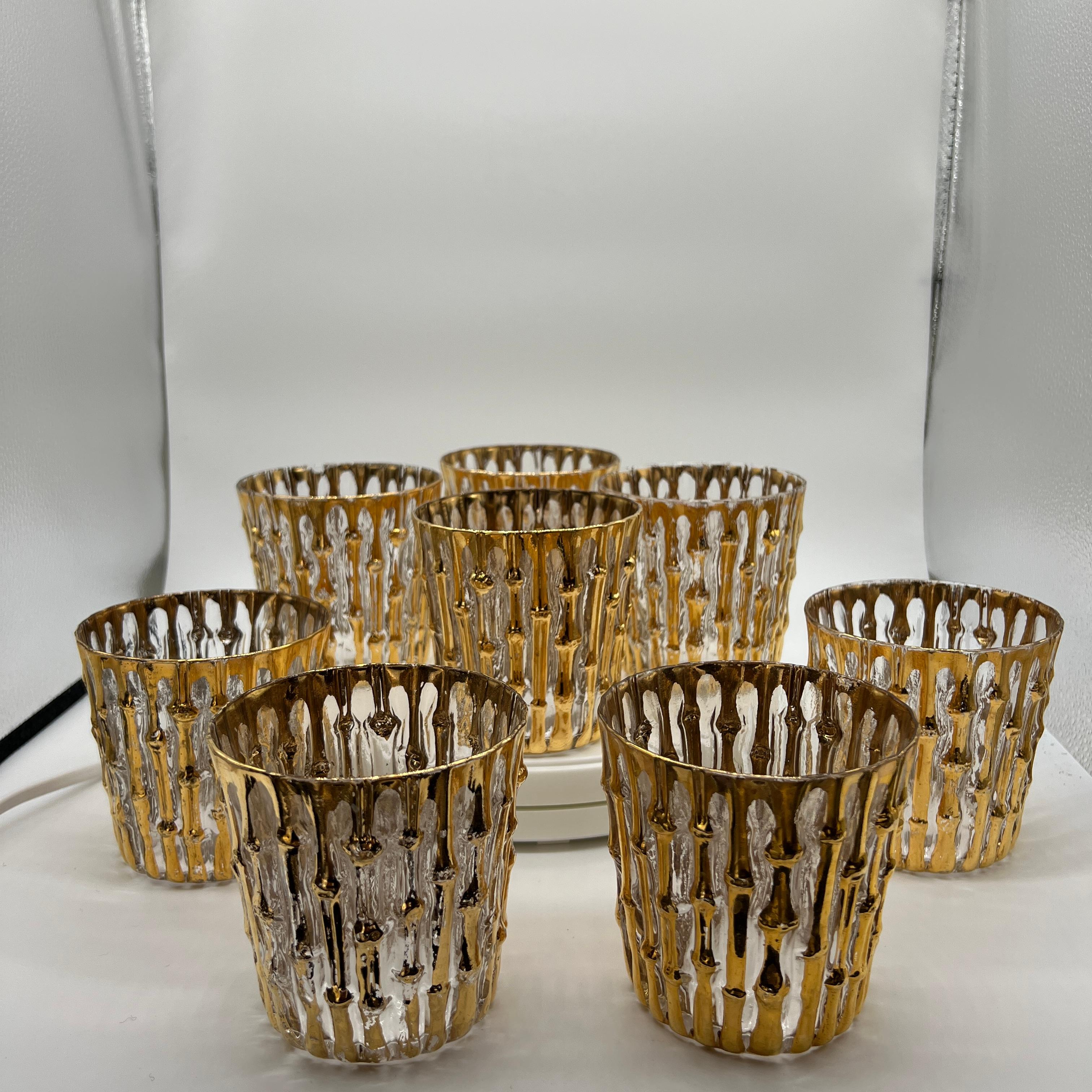 Rare set of 8 rocks glasses from Imperial Glass (Bellaire, OH). They are in very good condition with minimal loss close to the rim on a few glasses (see close up images). 22-karat gold hand painted bamboo pattern over an embossed texture (feels like
