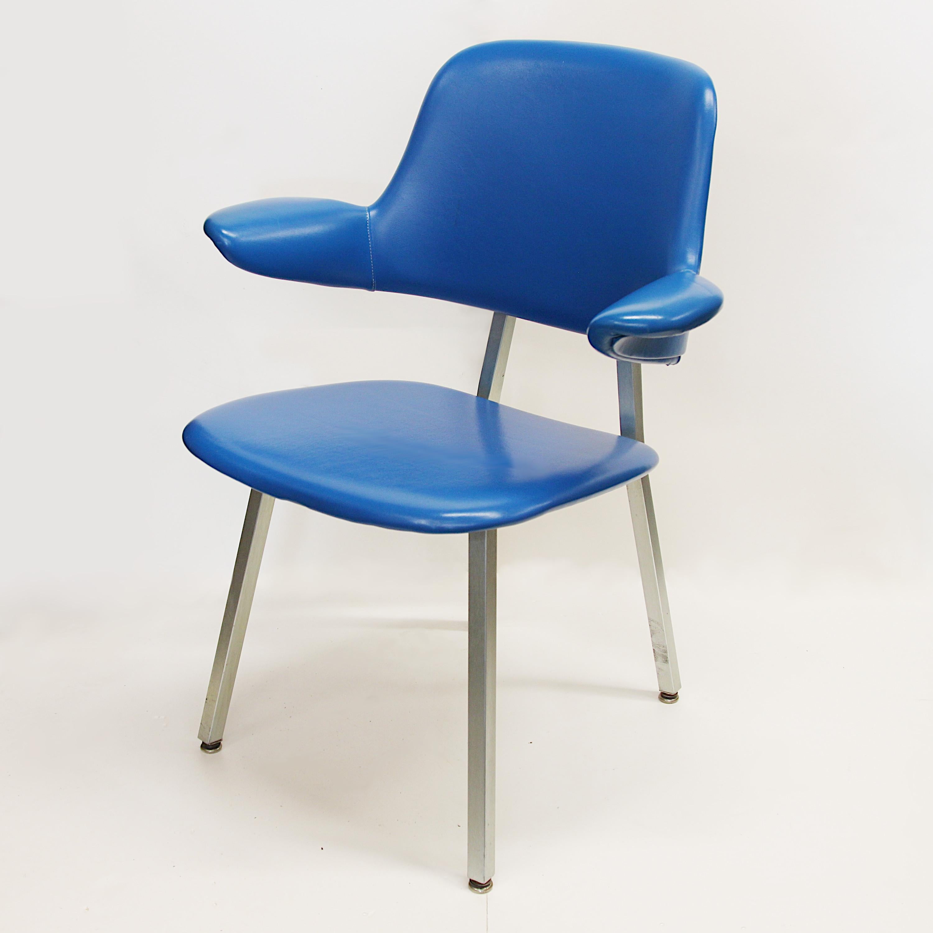 Wonderful set of 8 Model 420 armchairs by Shaw Walker. Chairs feature blue vinyl upholstery aluminum bases and unique floating-arm design.