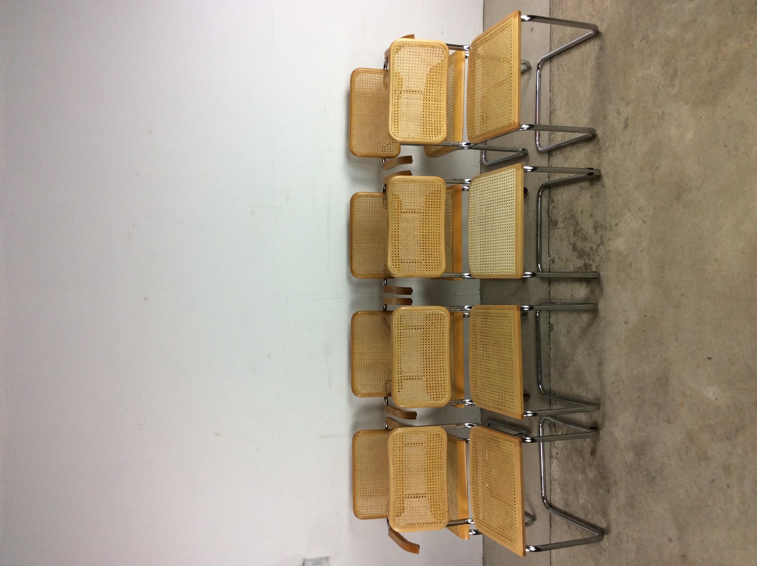 This set of eight Cesca dining chairs in the style of Marcel Breuer feature caned seat and back with hardwood frame and chrome cantilever base. ??4 side chairs, 4 arm chairs.

Dimensions: 23.75w 19d 33h 27.25ah 17.5sh

