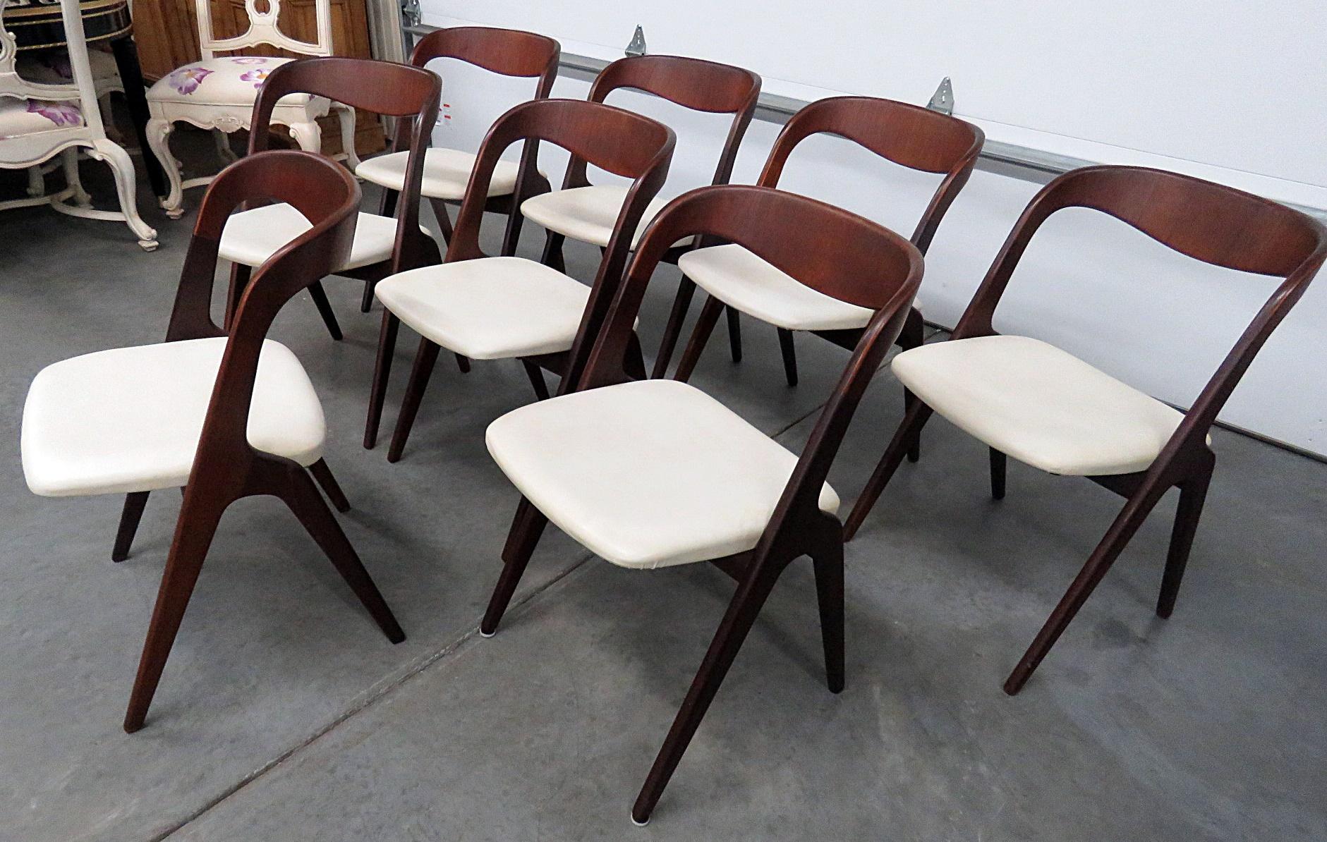 Set of 8 Danish Mid-Century Modern dining side chairs with Naugahyde upholstery.