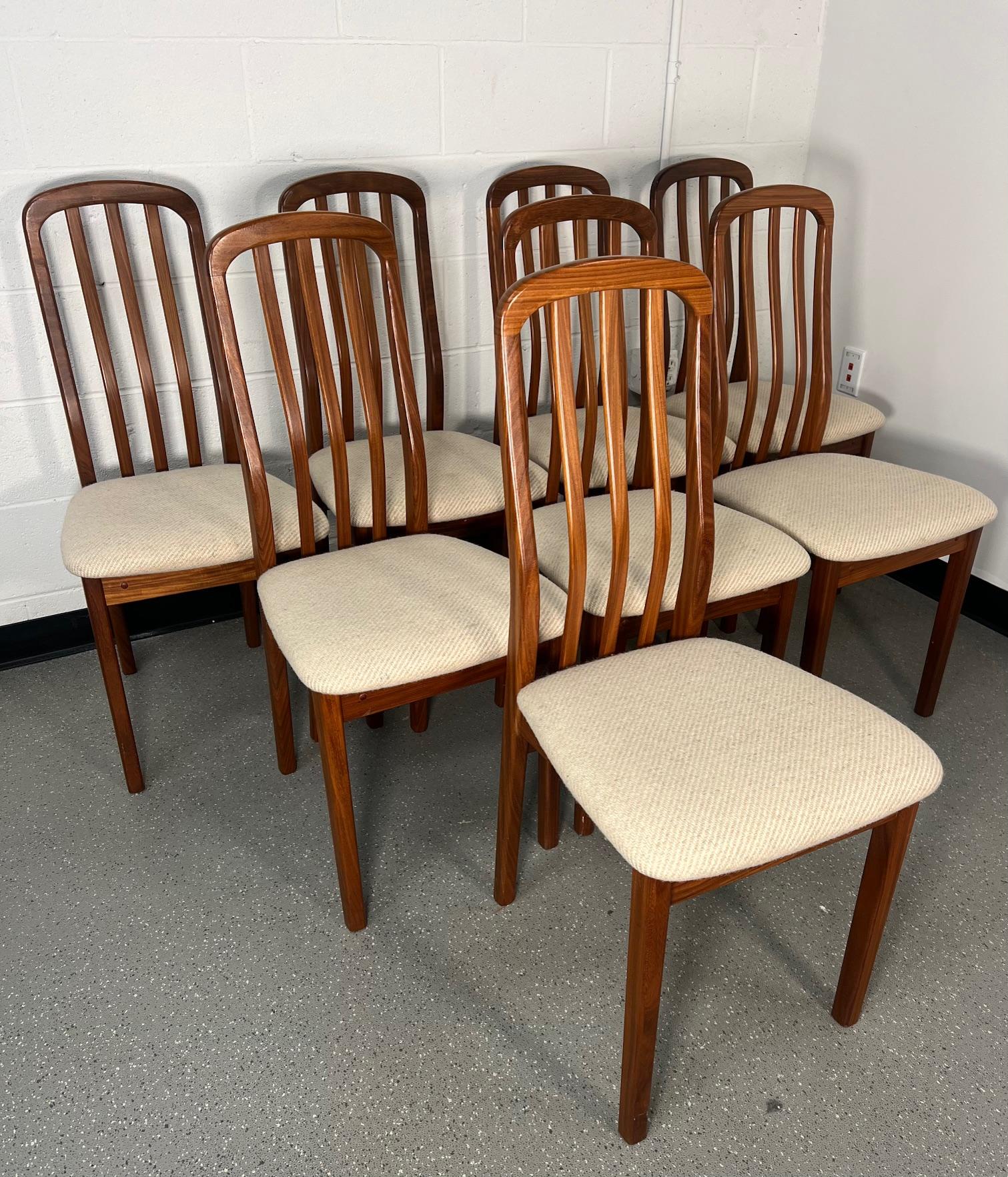 This is a stunning set of 8 Danish teak dining chairs. Slat back.

Frames in darker afromosia teak. A few spots here and there but look nice over all. Seat covers appear to be original and are also still very nice. A few spots here and there.