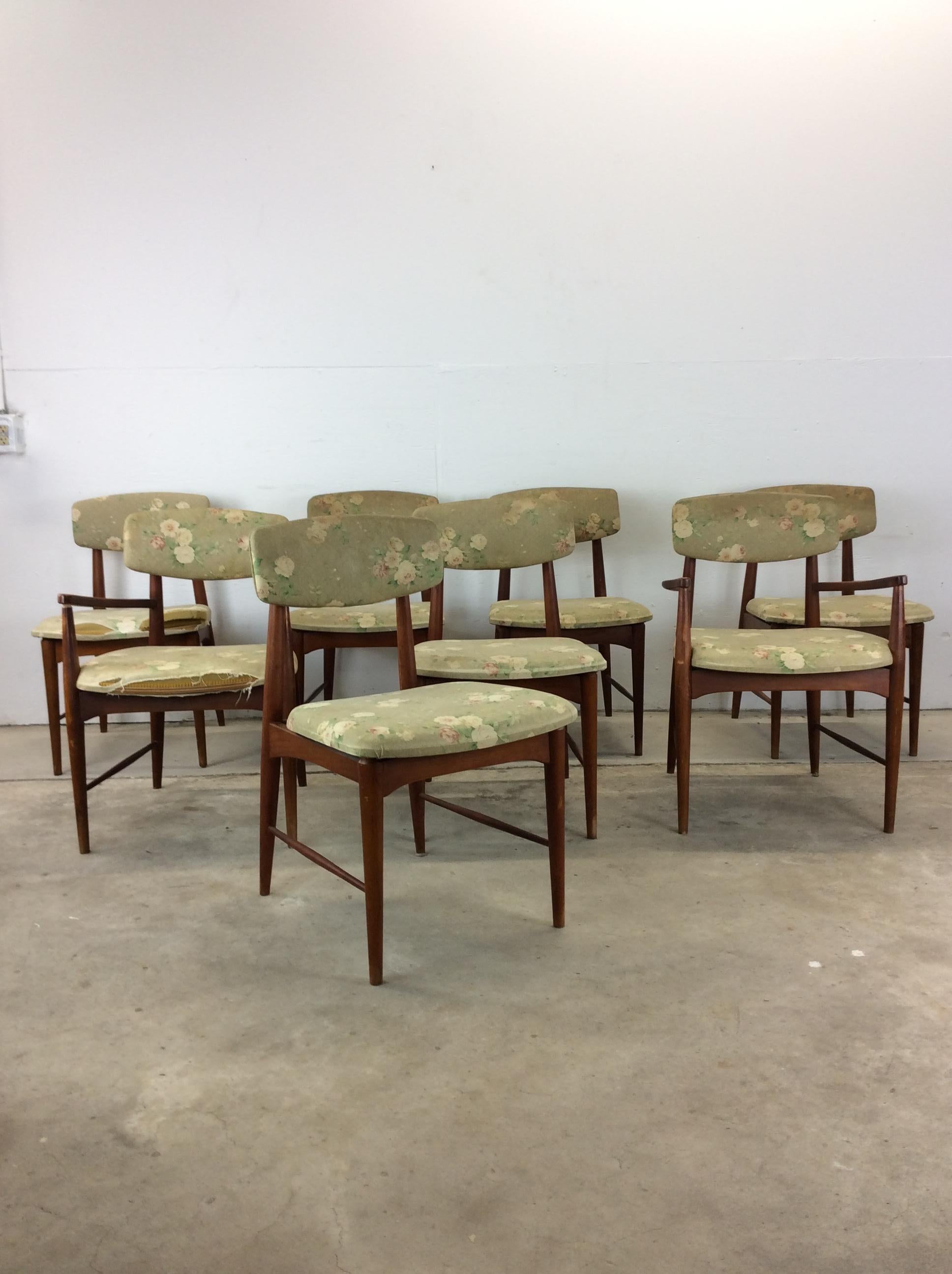 This set of 8 mid century modern dining chairs features hardwood construction, original walnut finish, vintage (but not original) floral upholstery, solid wood armrests and tall tapered legs.  Set of 8 includes 2 arm chairs and six side