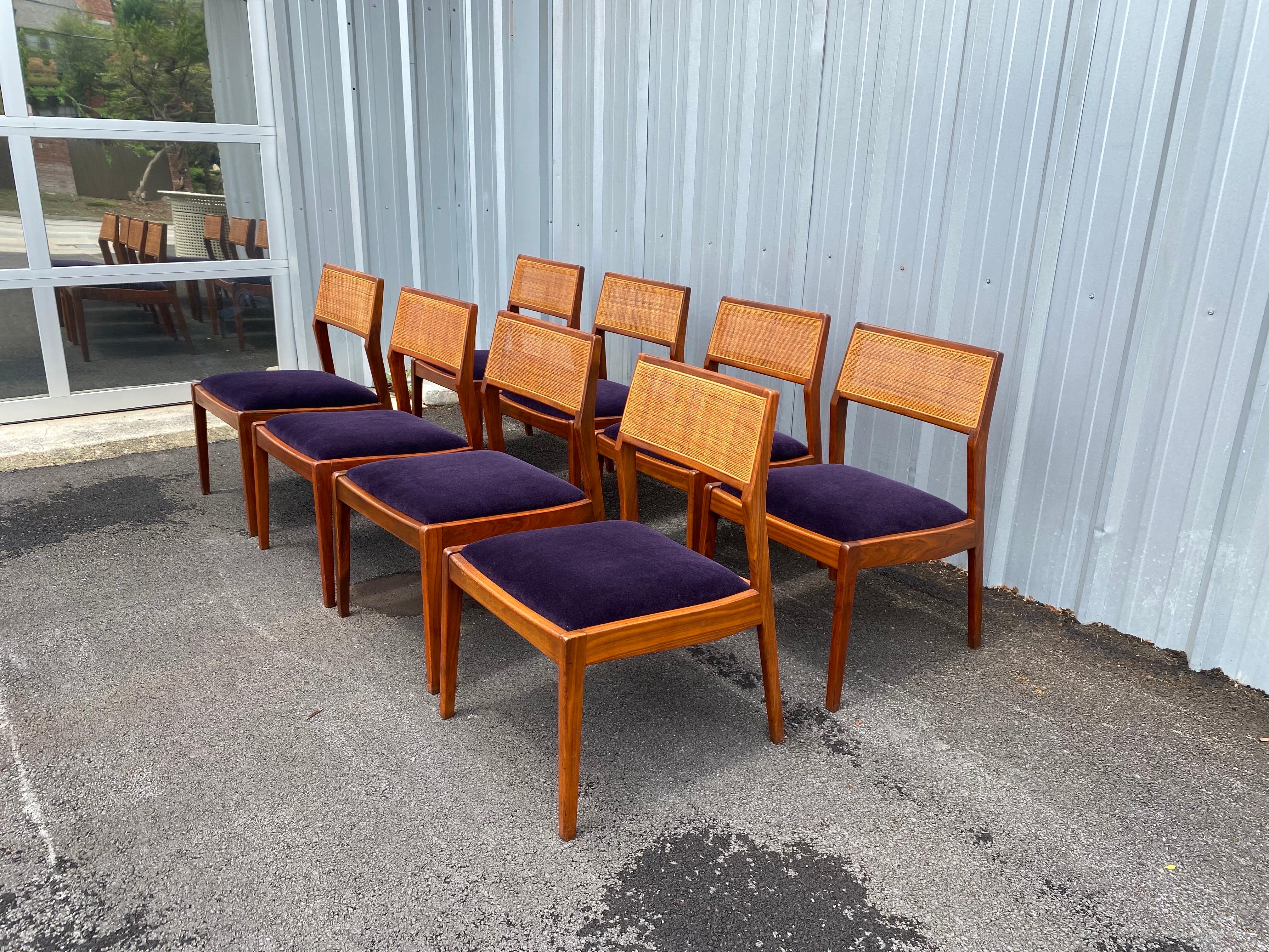 Beautiful set of 8 mid-century modern dining chairs by Foster-McDavid with a caned back and is made of walnut. The dining chairs have been newly reupholstered with a very fine aubergine mohair fabric. Normal age-appropriate wear on one chair located