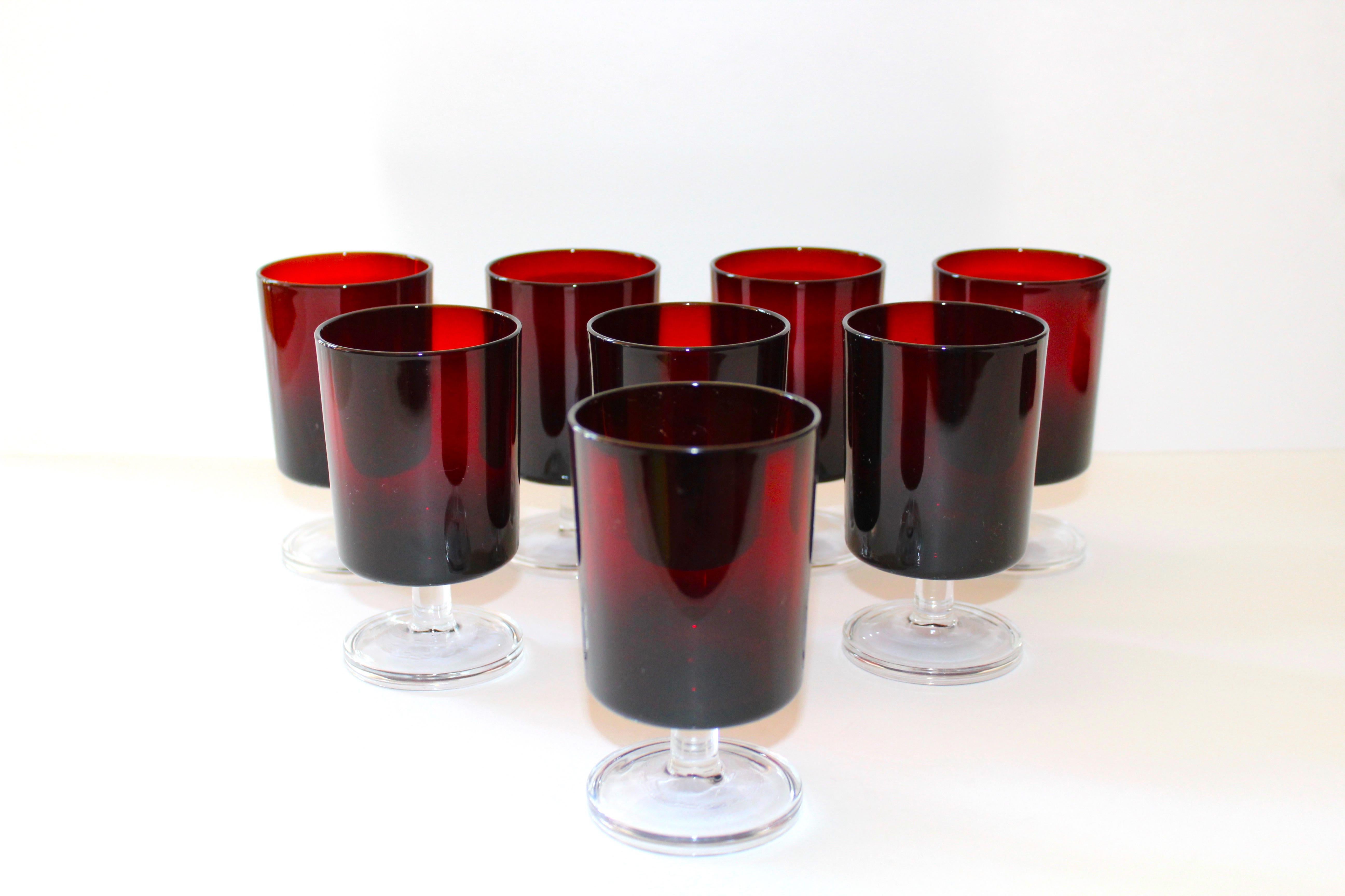 Set of eight vintage crystal wine goblets or liquor glasses in a gorgeous deep garnet red with clear glass stems. Glasses have minimalist design with cylinder forms. Stamped 