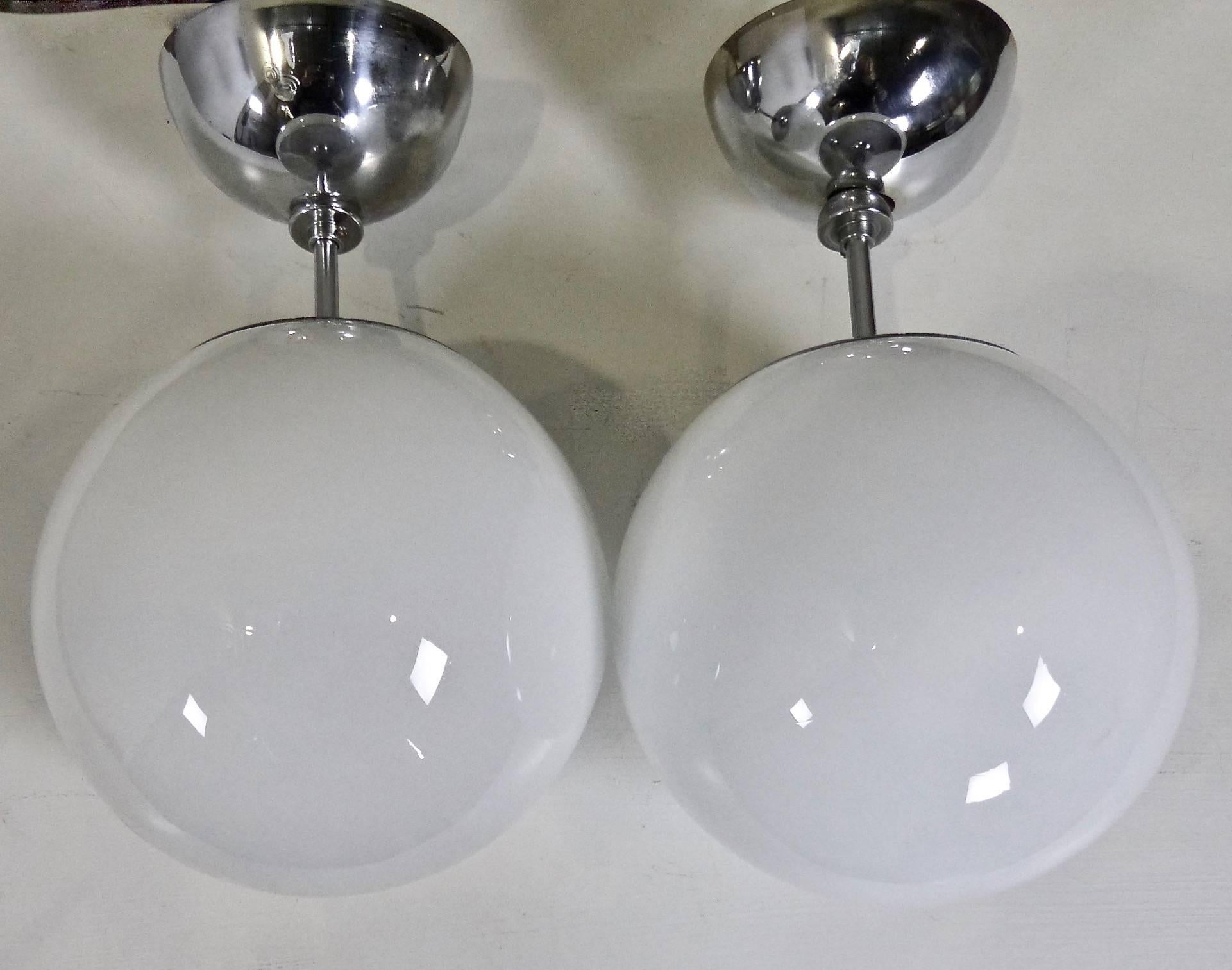 Mid-Century Modern Set of four Mid Century Pendant Fixtures with Spherical Milk Glass Globes For Sale