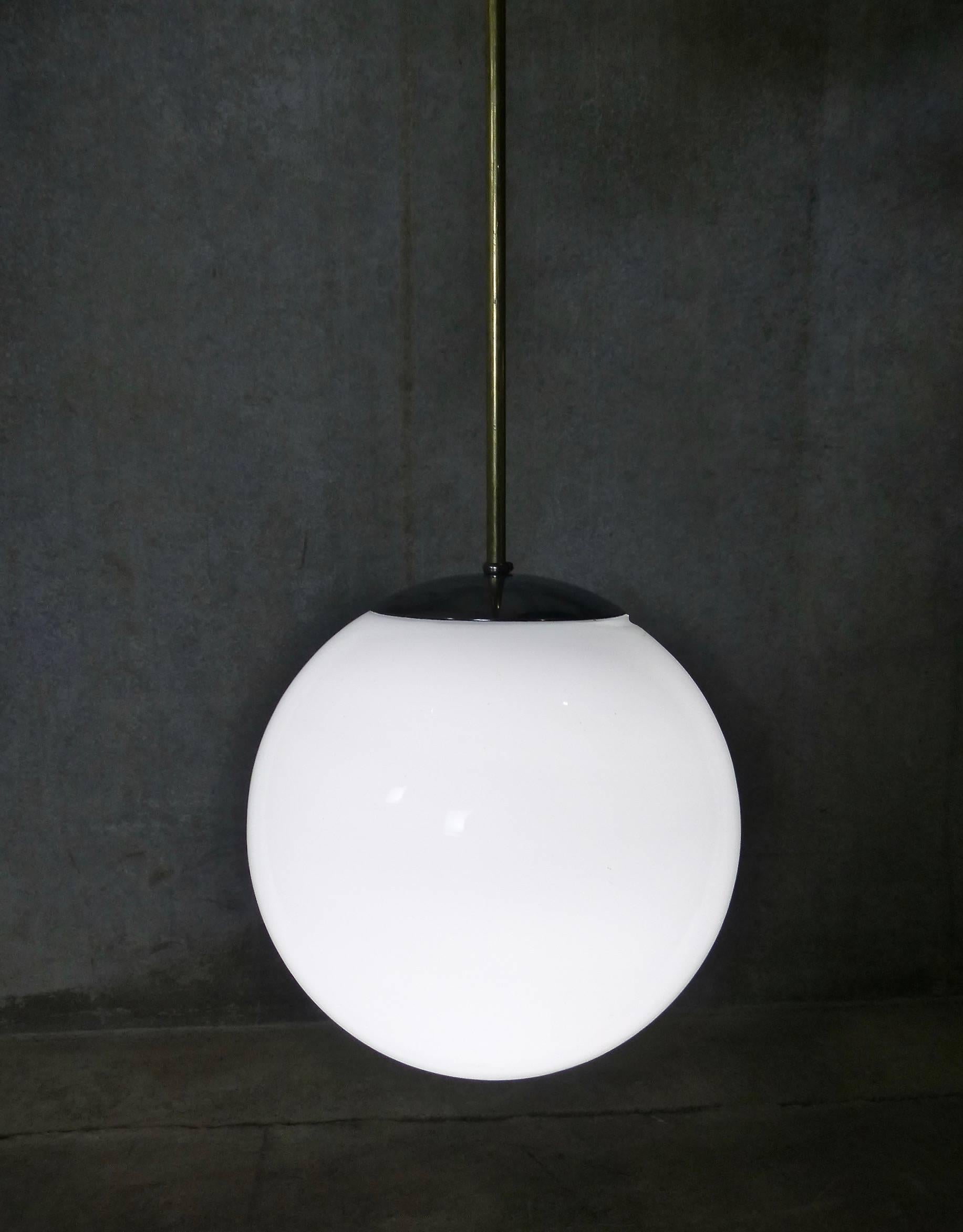 American Set of four Mid Century Pendant Fixtures with Spherical Milk Glass Globes For Sale