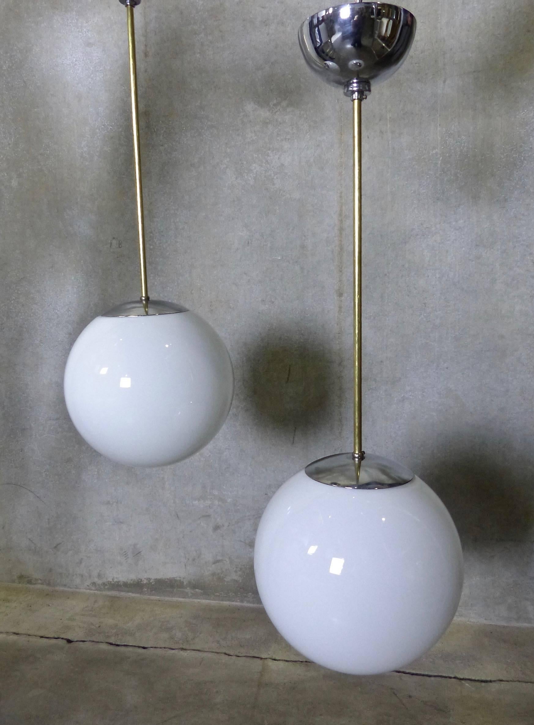 Mid-20th Century Set of four Mid Century Pendant Fixtures with Spherical Milk Glass Globes For Sale