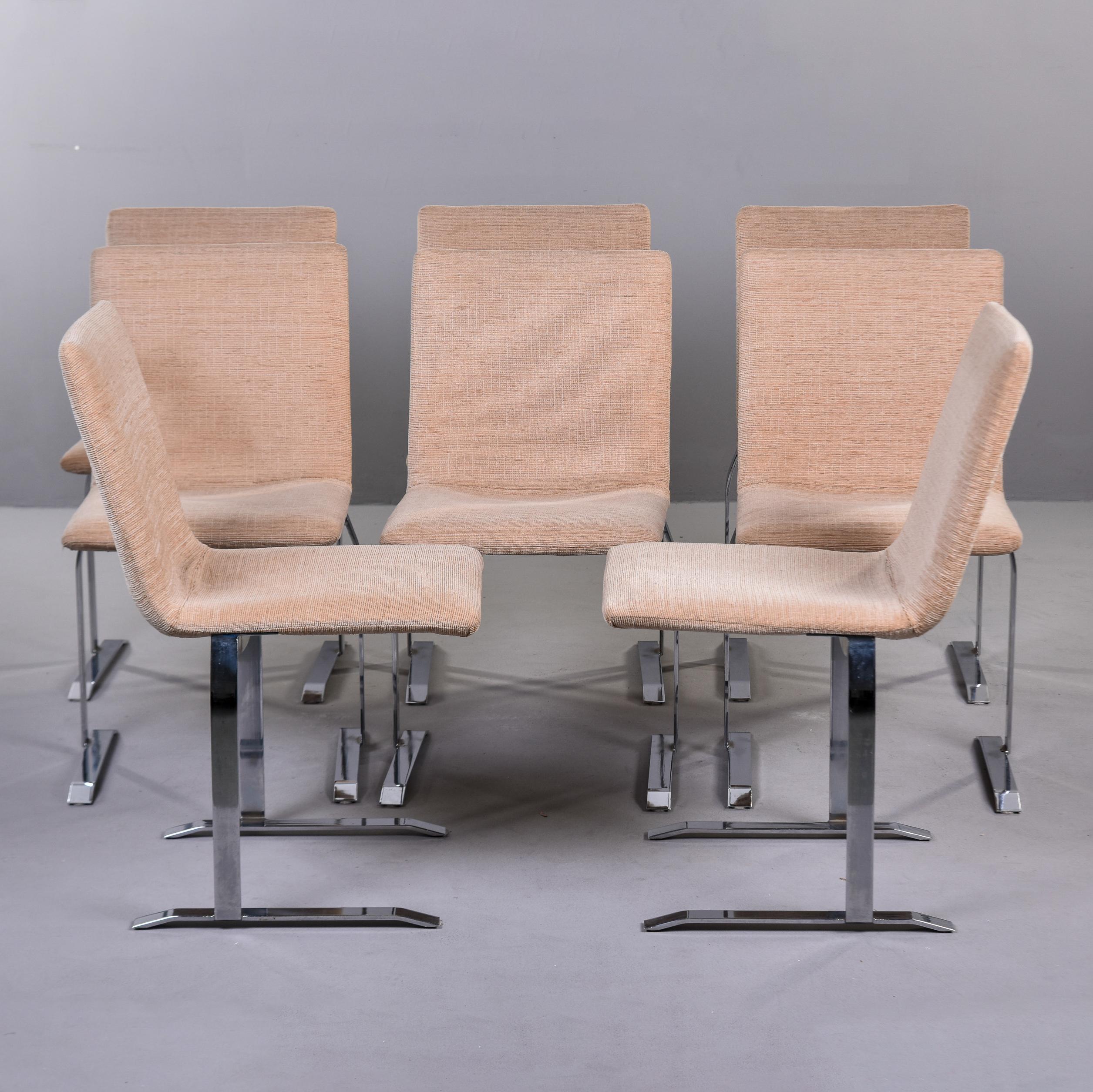 Circa 1970s set of eight chairs by Italian designer Giovanni Offredi for Saporiti. Chairs have a sleek, curved and armless body with streamlined stainless steel legs and feet. Still upholstered in what we believe is the original sand colored