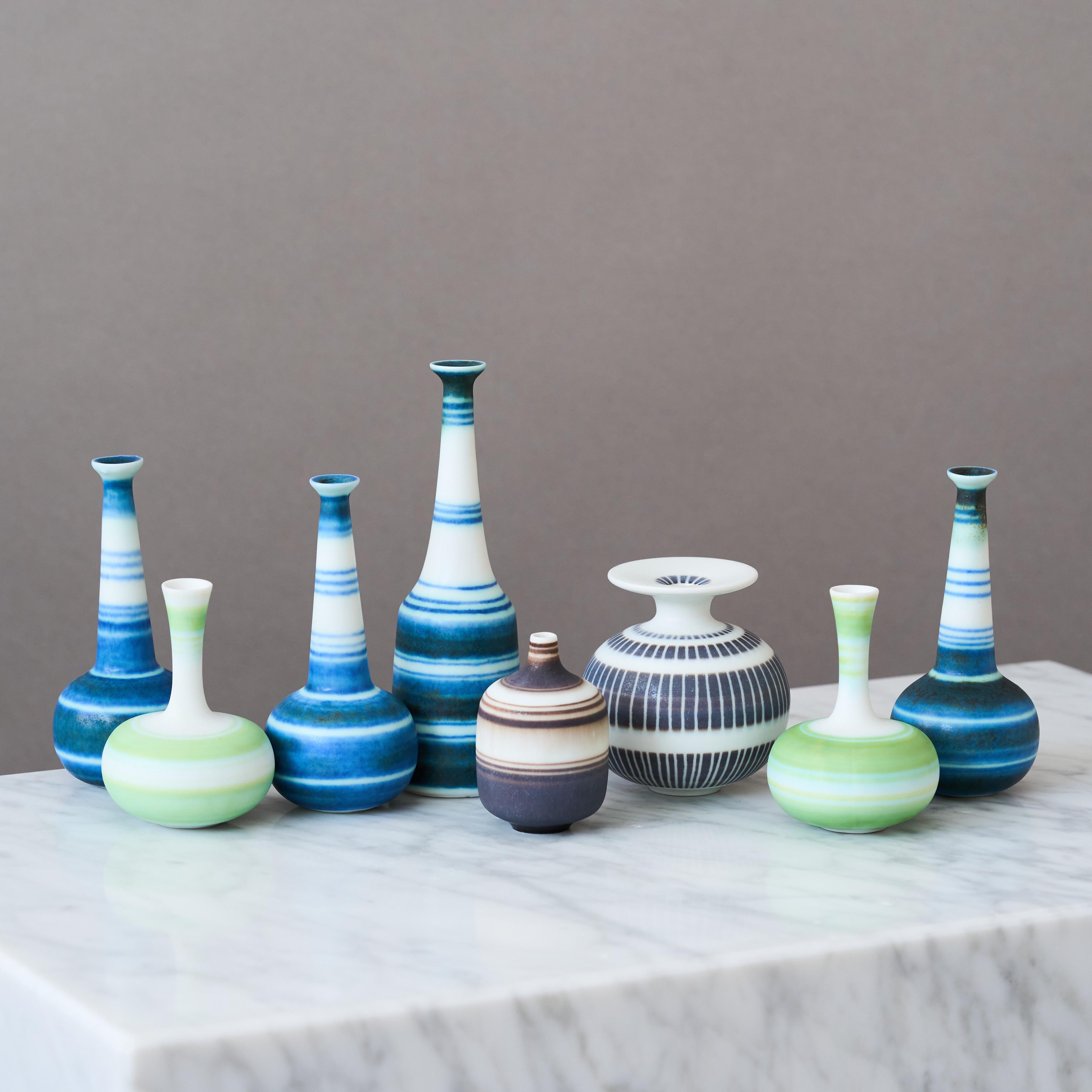 A set of eight beautiful and colourful stoneware vases with amazing decor. 
Made by Gunnar Nylund for Rorstrand, Sweden, 1950s.

Great condition. 
Signed with 'GN' and makers mark.

Gunnar Nylund (1904-1997) was born in Paris, France. His parents
