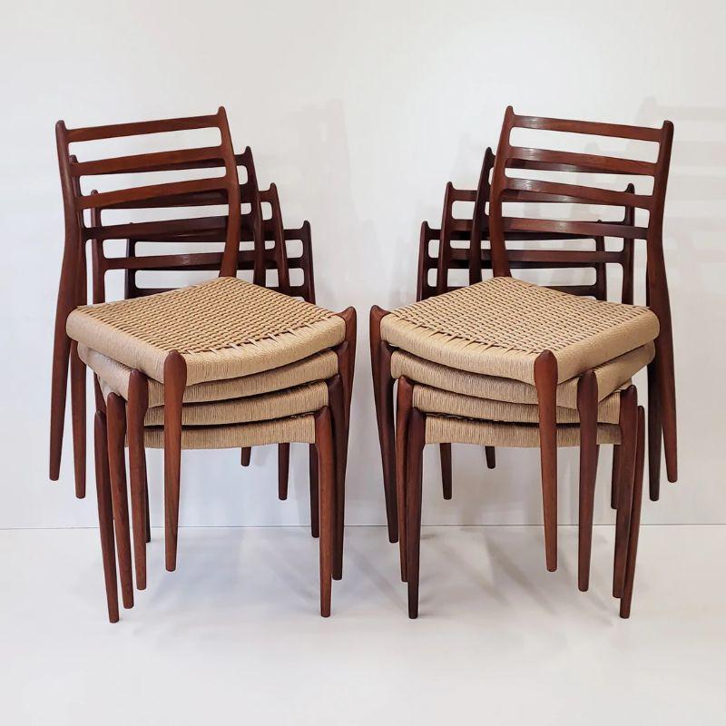 Set of eight model 78 teak dining chairs designed by Niels Otto. Møller for J.L. Moller Mobelfabrik, Denmark in 1962. Seats re woven with natural Danish paper cord. All restoration and weaving work is undertaken at our workshop. 

Designer: Niels