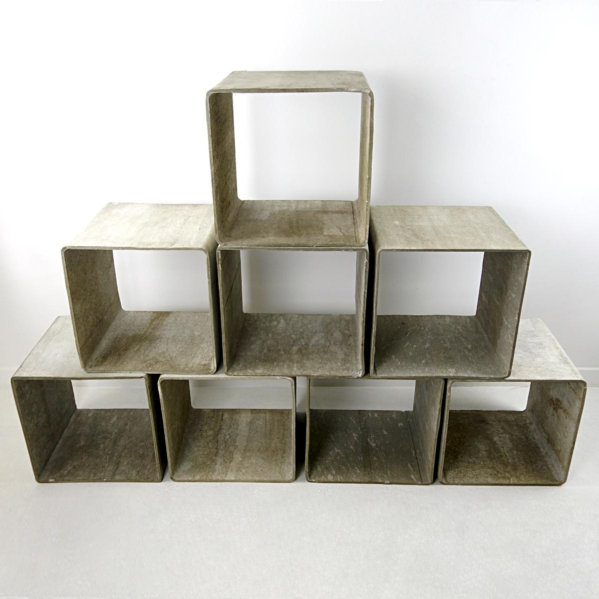 The Swiss designer Willy Guhl is mostly known for his famous planters but he designed other beautiful items as well, such as these marvelous cubes that may serve as bookcases or displays for your collection of ceramics for instance. 
This set of