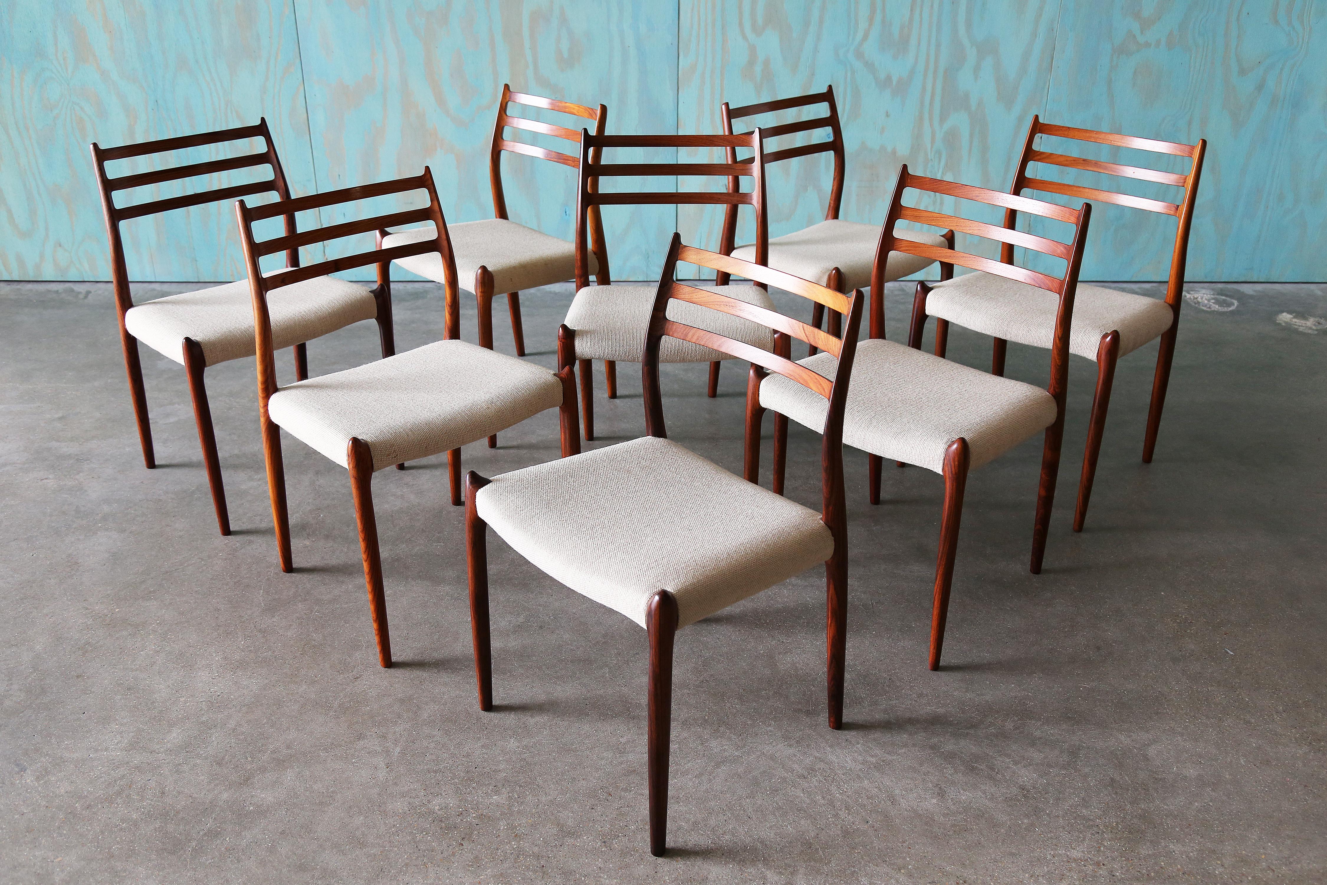 An exquisite set of 8 rosewood Niels O Moller model 78 chairs.  Featuring original danish wool seats.  These chairs came from a single owner family and were imported from Denmark when they moved to the United States. Rarely used these chairs are