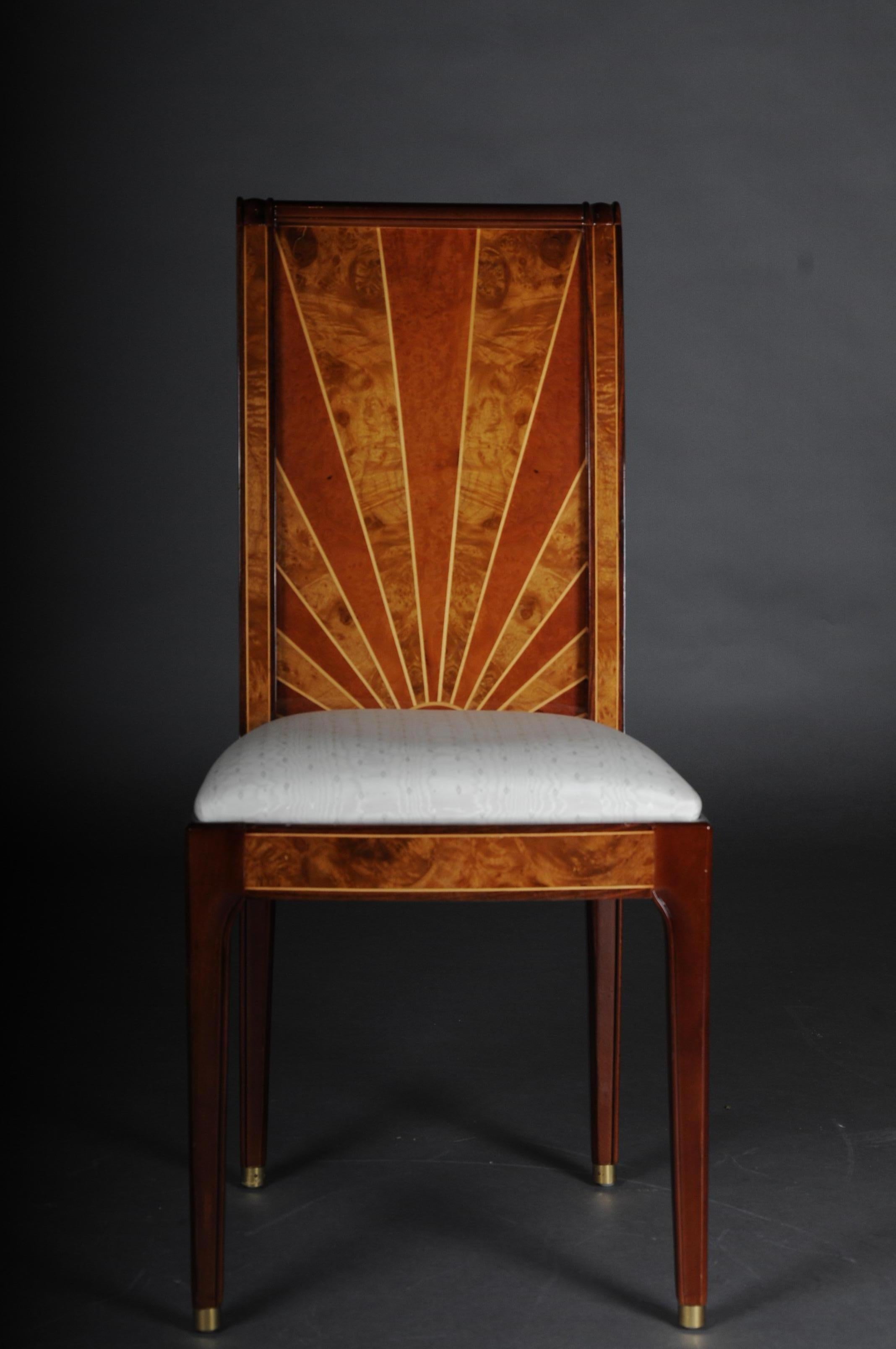 Set of 8 old chairs in Art Deco design.

Root veneer with inlays on solid wood. Straight frame ending on pointed square legs in sabots. Rectangular board-shaped backrest imitation with highly interesting veneer picture in the form of sun rays.